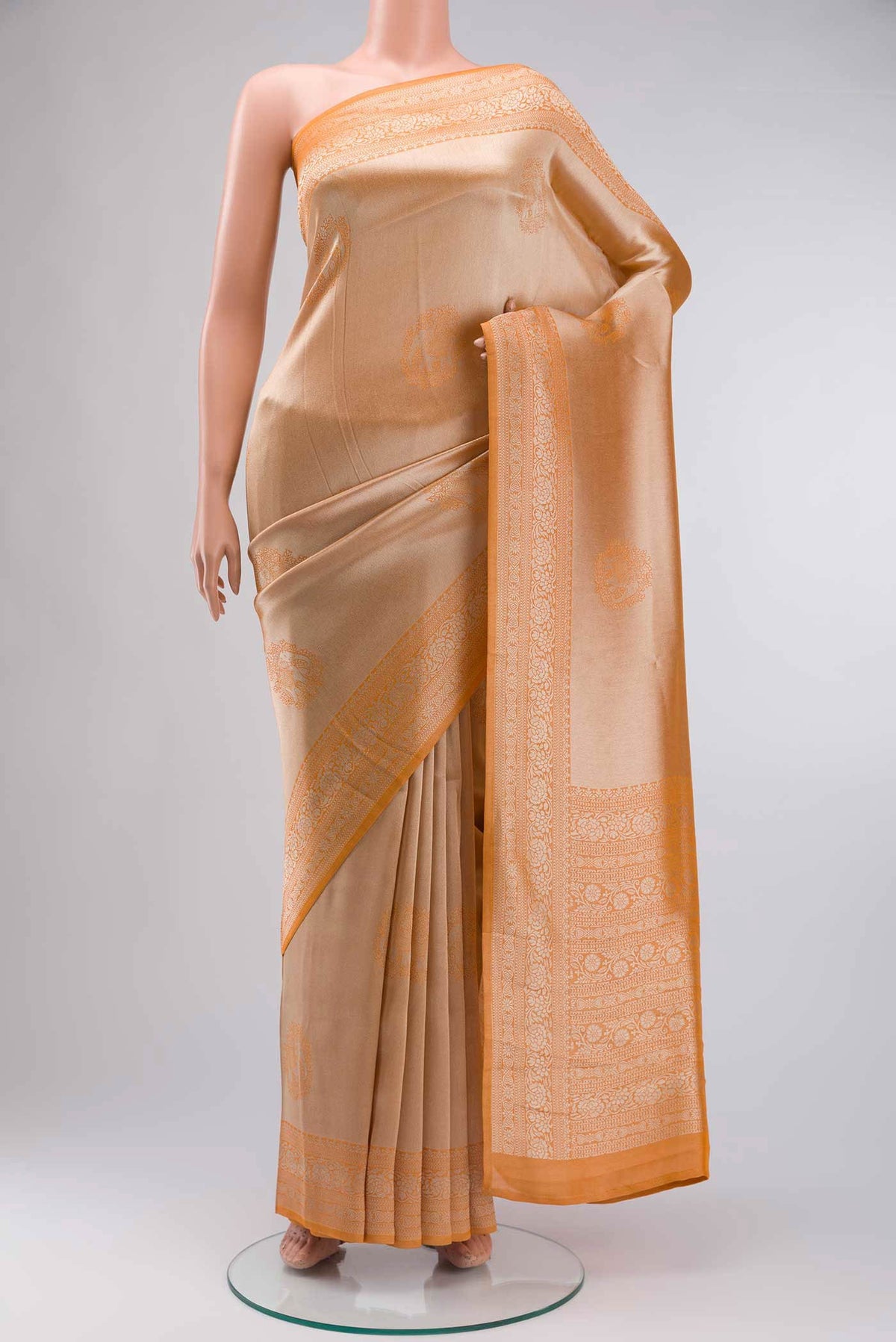 Orange Blended Art Silk Saree with Zari Butta on the body and Zari Border displayed on a mannequin
