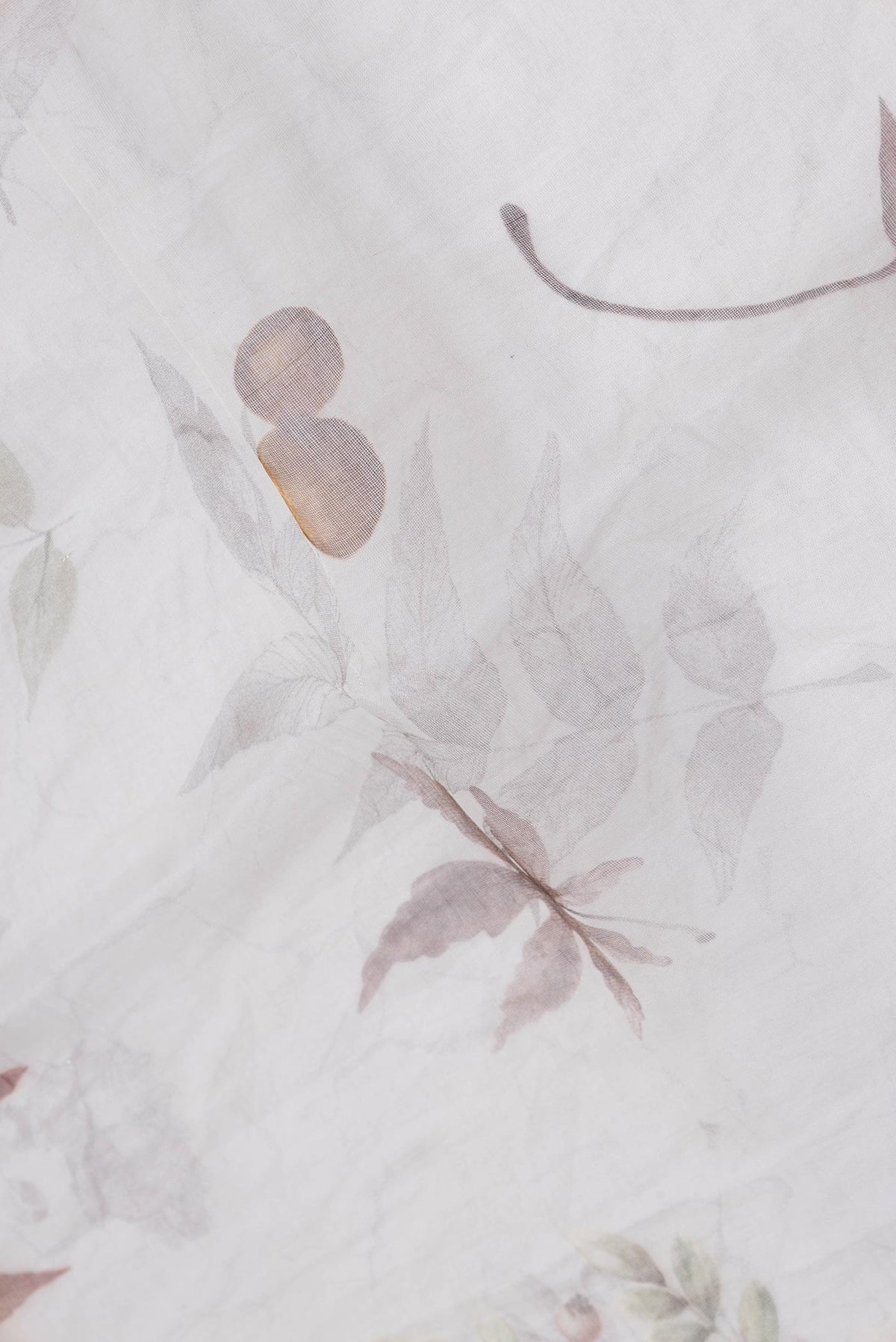 Close up of Off White Dual Tone Linen Saree with Printed design on the body and Without Border.  displaying folds