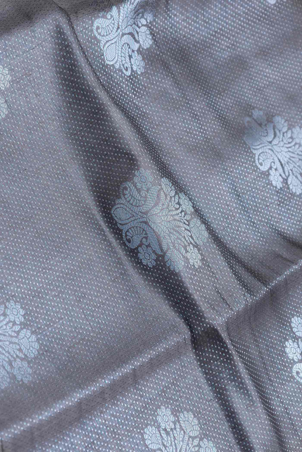 Close up of Grey Banarasi Raw Silk Saree with Zari Brocade on the body and Zari Border displaying folds