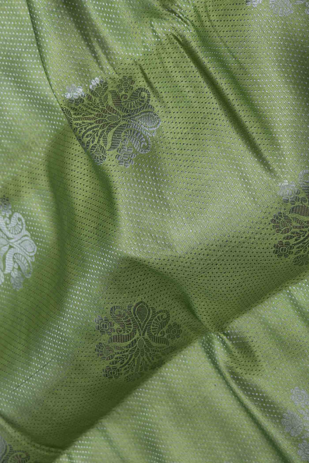Close up of Green Dual Tone Tussar Saree with Zari Brocade on the body and Zari Border displaying folds