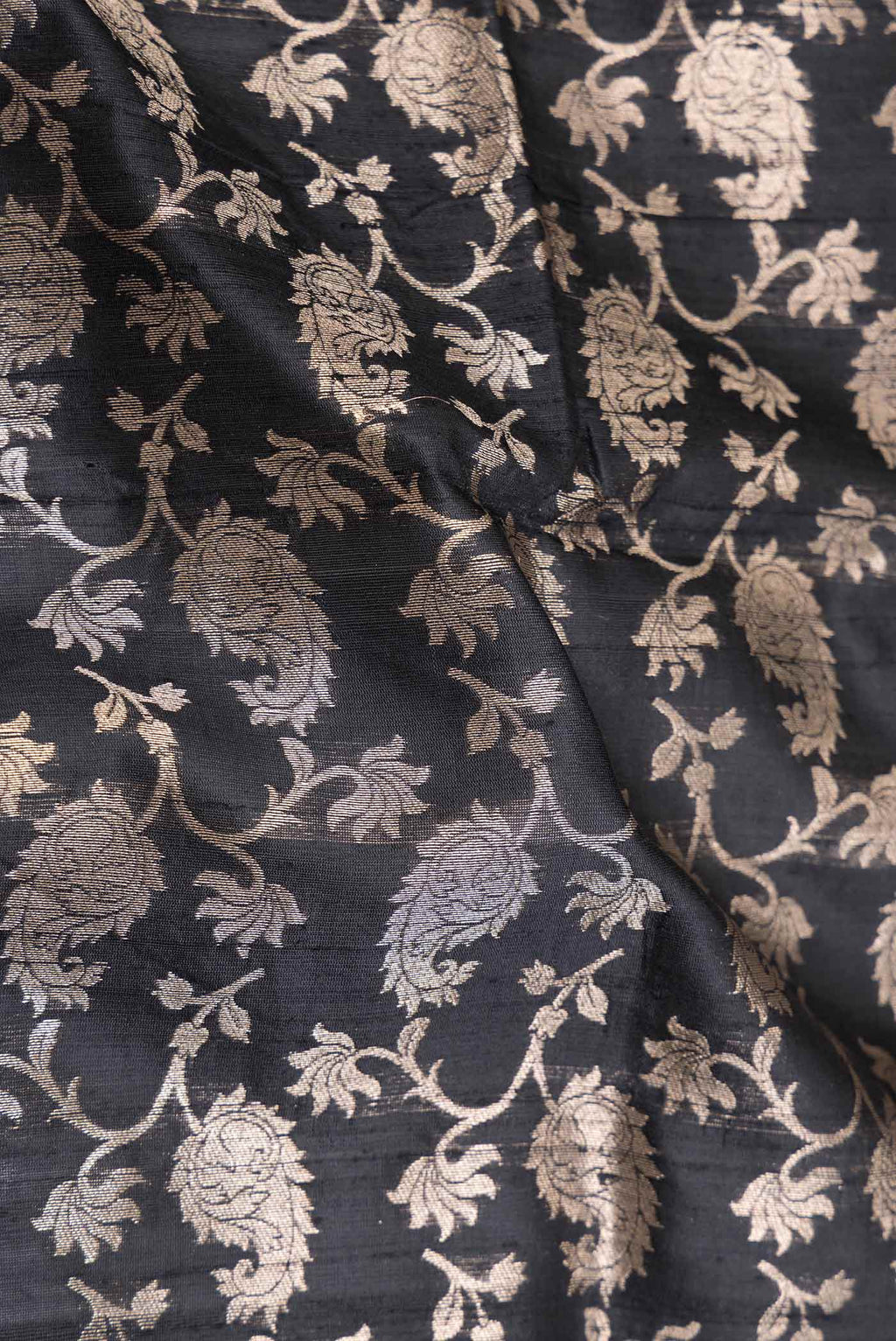 Close up of Black Dual Tone Raw Silk Saree with Zari Brocade on the body and Zari Border displaying folds
