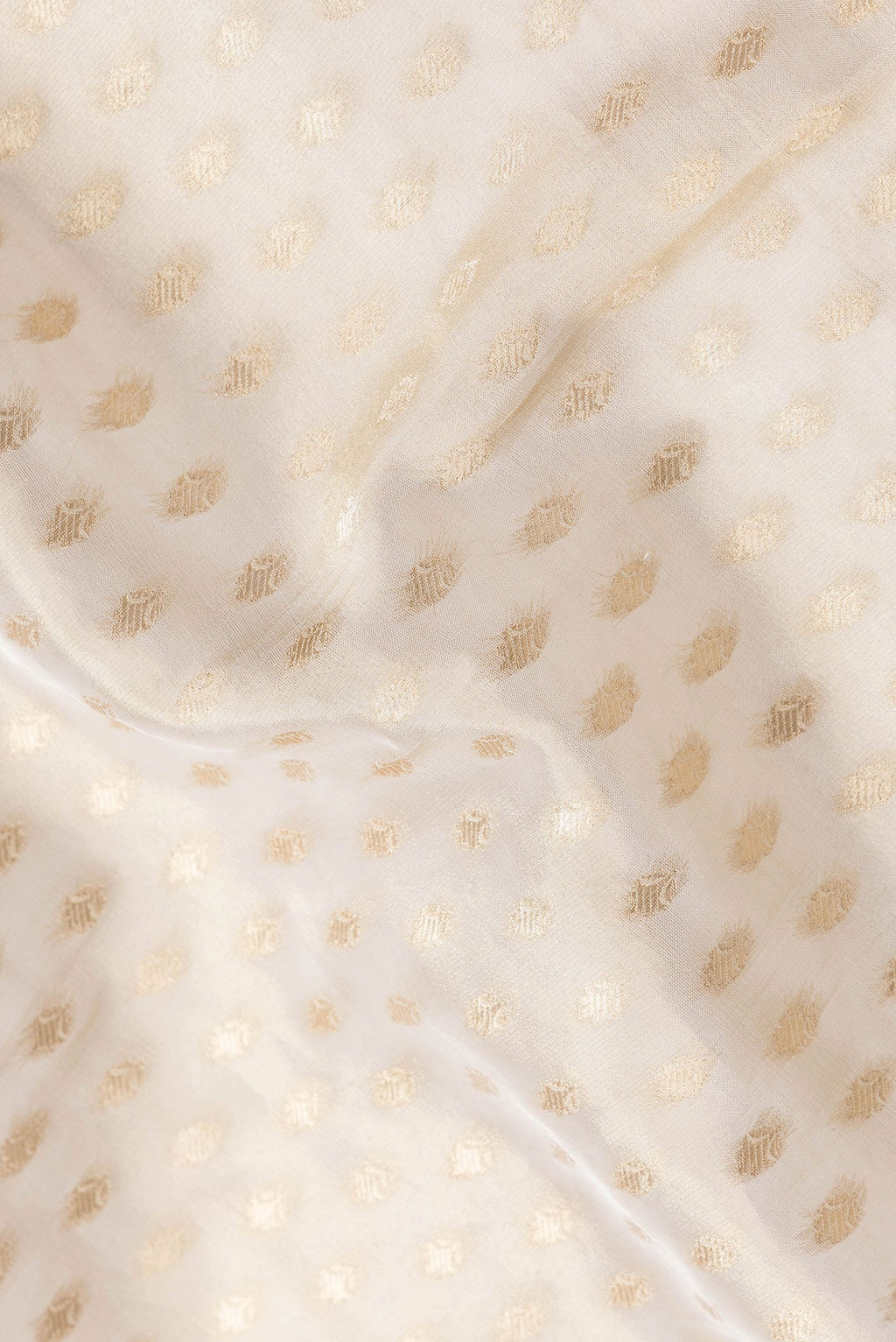 Close up of Gold Dual Tone Banarasi Georgette Saree with Zari Brocade on the body and Embroidery Border.  displaying folds