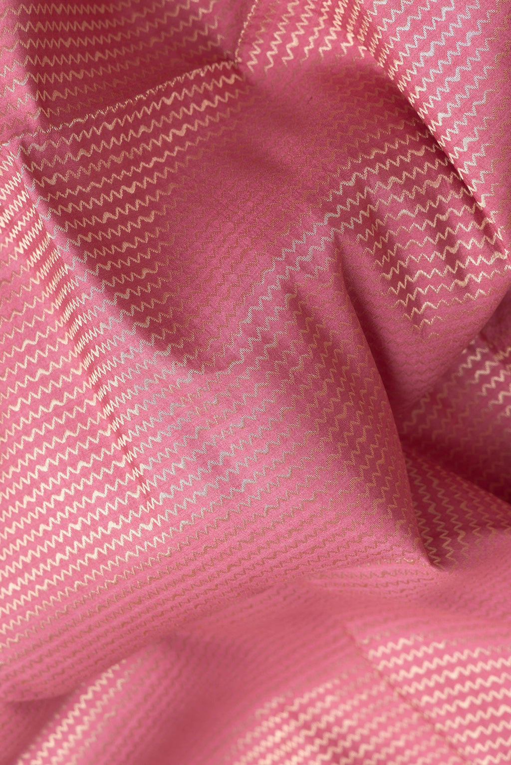 Close up of Pink Dual Tone Banarasi Raw Silk Saree with Zari Brocade on the body and Zari Border.  displaying folds