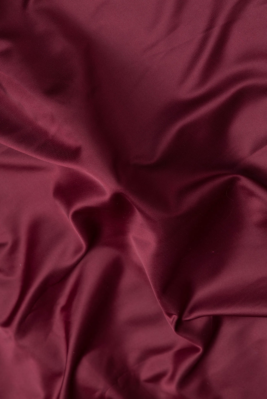 Close up of Maroon Dual Tone Blended Banarasi Silk Saree with Plain Body and Zari Border.  displaying folds
