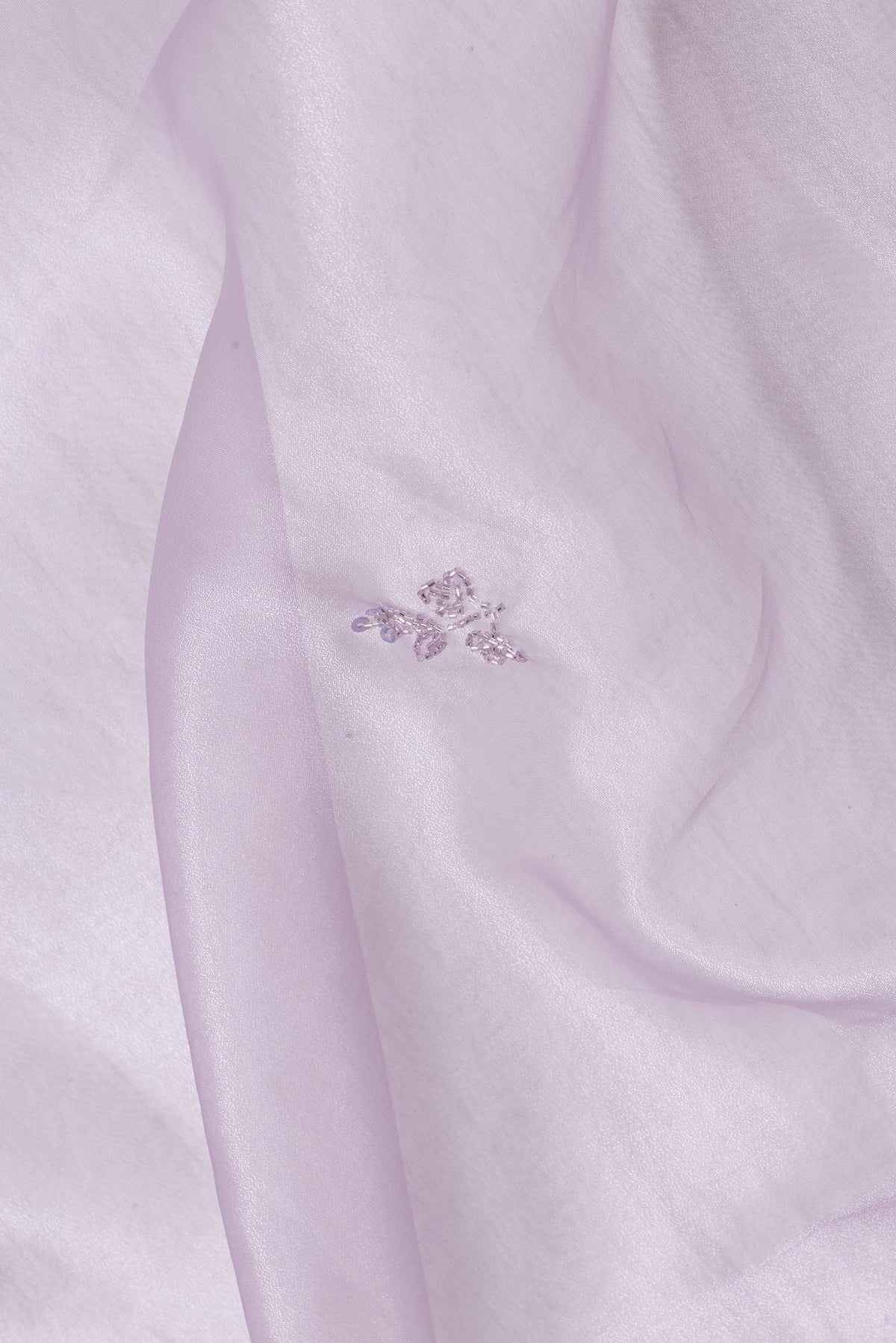 Close up of Lavender Dual Tone Organza Silk Saree with Embroidery on the body and Embroidery Border.  displaying folds