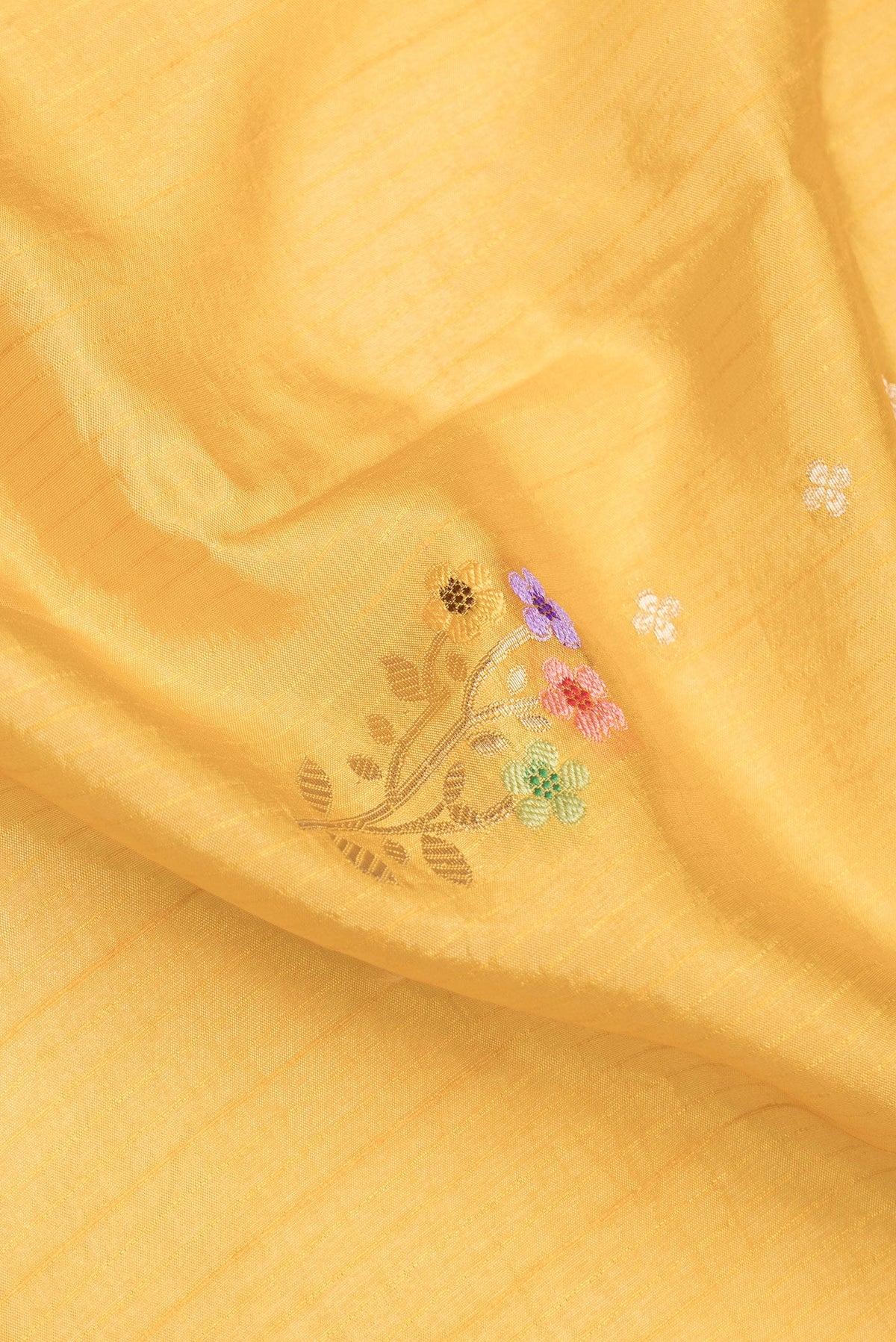Close up of Mustard Dual Tone Tussar Silk Saree with Zari Butta on the body and Zari And Thread Border.  displaying folds