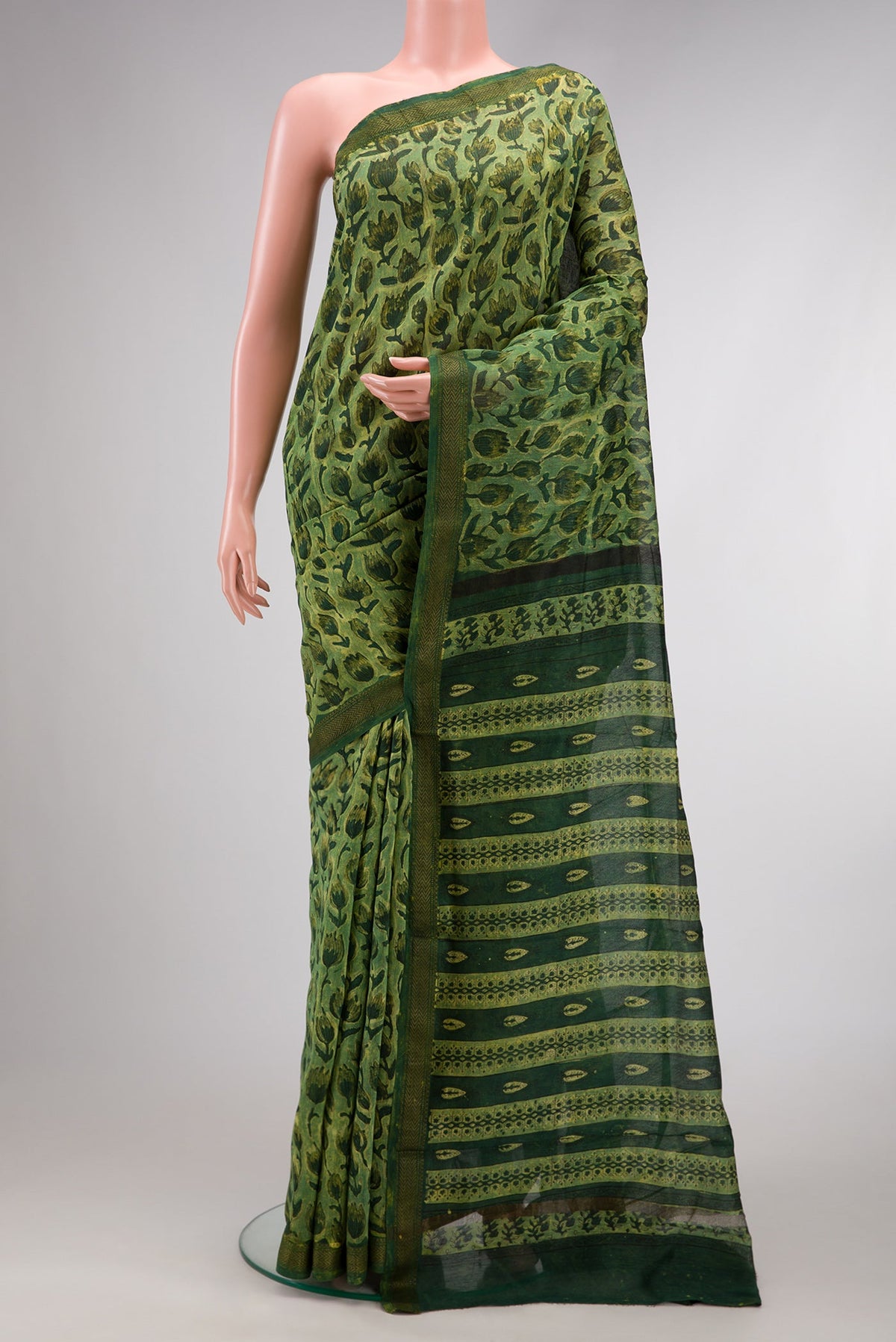 Green Dual Tone Tussar Silk Saree with Printed design on the body and Zari Border.  displayed on a mannequin