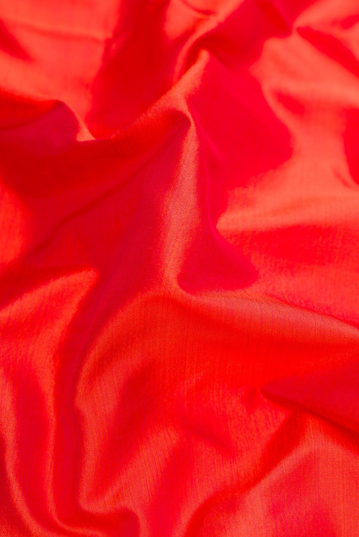 Close up of Orange Dual Tone Kanchipuram Silk Nine Yards Saree with Plain Body and Zari Border.  displaying folds