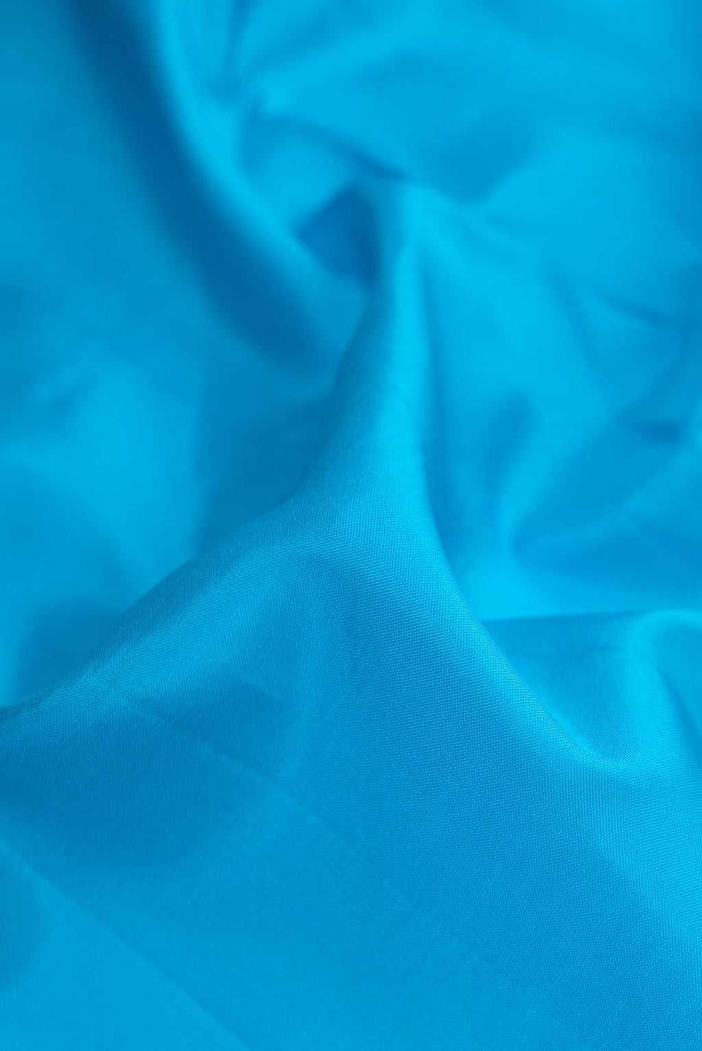 Close up of Sky Blue Dual Tone Kanjivaram Silk Nine Yards Saree with Plain Body and Zari Border.  displaying folds