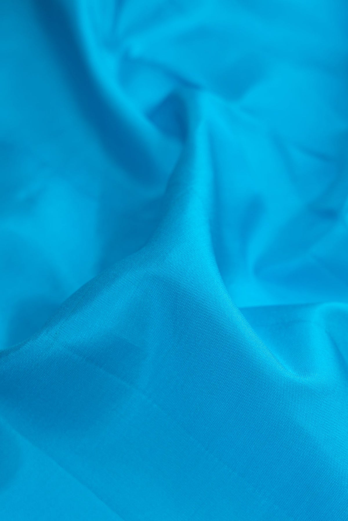 Close up of Sky Blue Dual Tone Kanjivaram Silk Nine Yards Saree with Plain Body and Zari Border.  displaying folds
