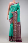 Sea Green Dual Tone Gadwal Silk Saree with Checked design on the body and Zari Border.  displayed on a mannequin