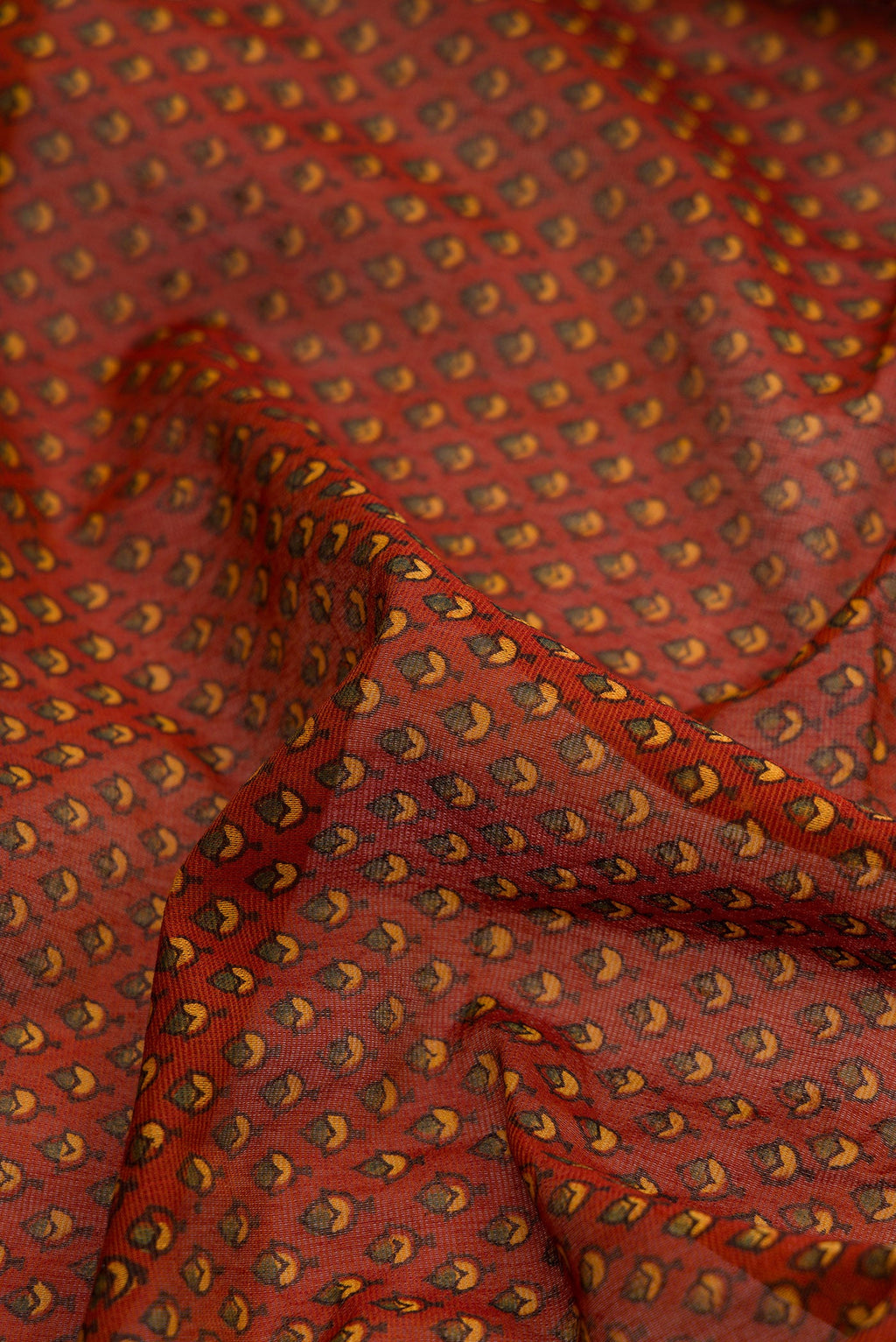 Close up of Orange Dual Tone Cotton Saree with Ajrakh Print on the body and Zari Border.  displaying folds