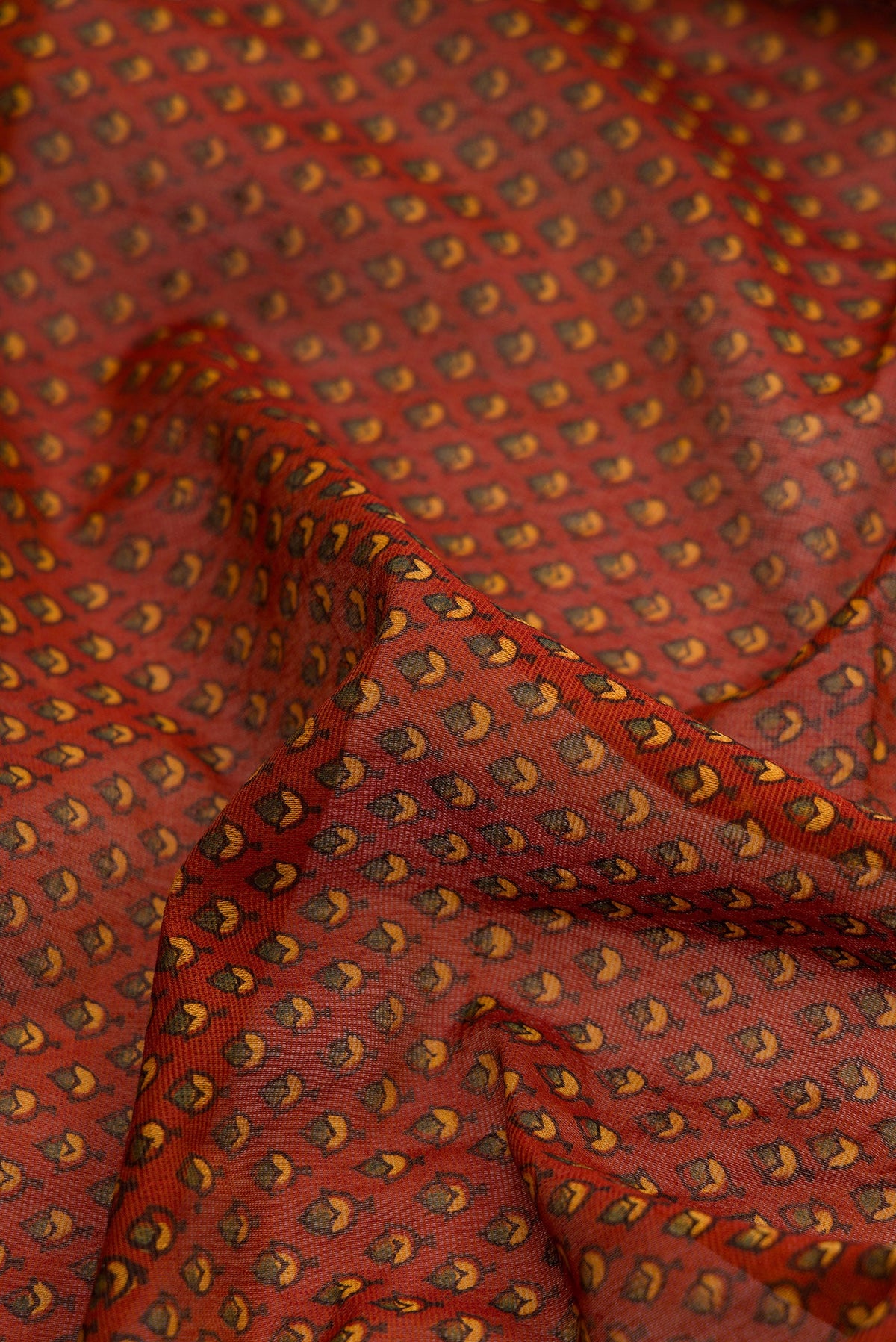 Close up of Orange Dual Tone Cotton Saree with Ajrakh Print on the body and Zari Border.  displaying folds