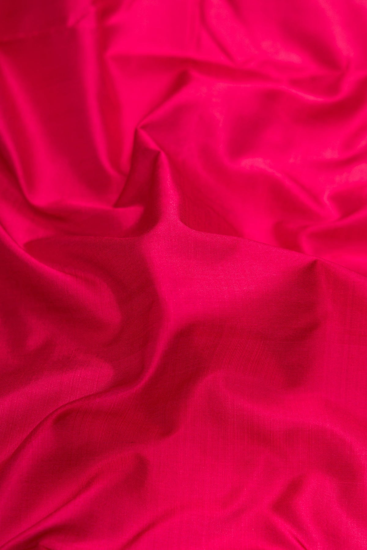 Close up of Maroon Dual Tone Kanchipuram Silk Nine Yards Saree with Plain Body and Zari Border.  displaying folds