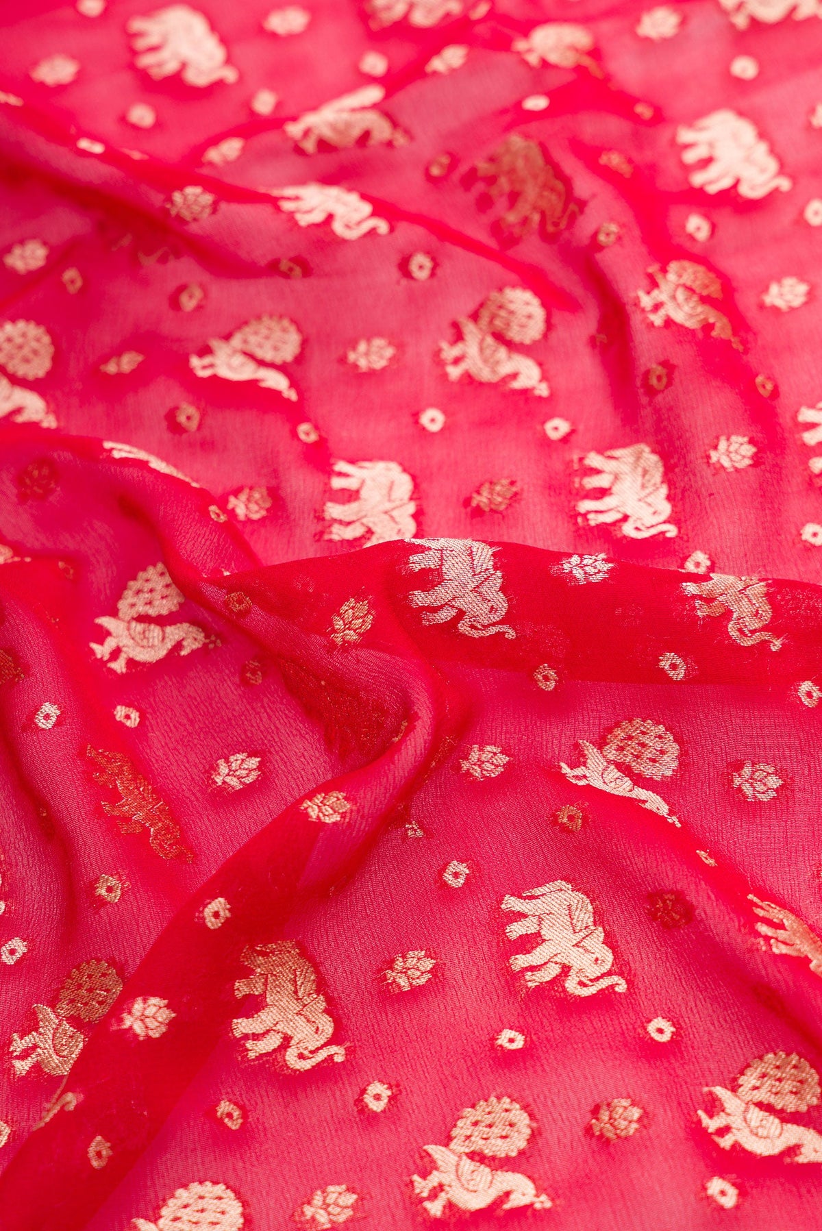 Close up of Maroon Dual Tone Banarasi Georgette Saree with Zari Butta on the body and Zari Border.  displaying folds