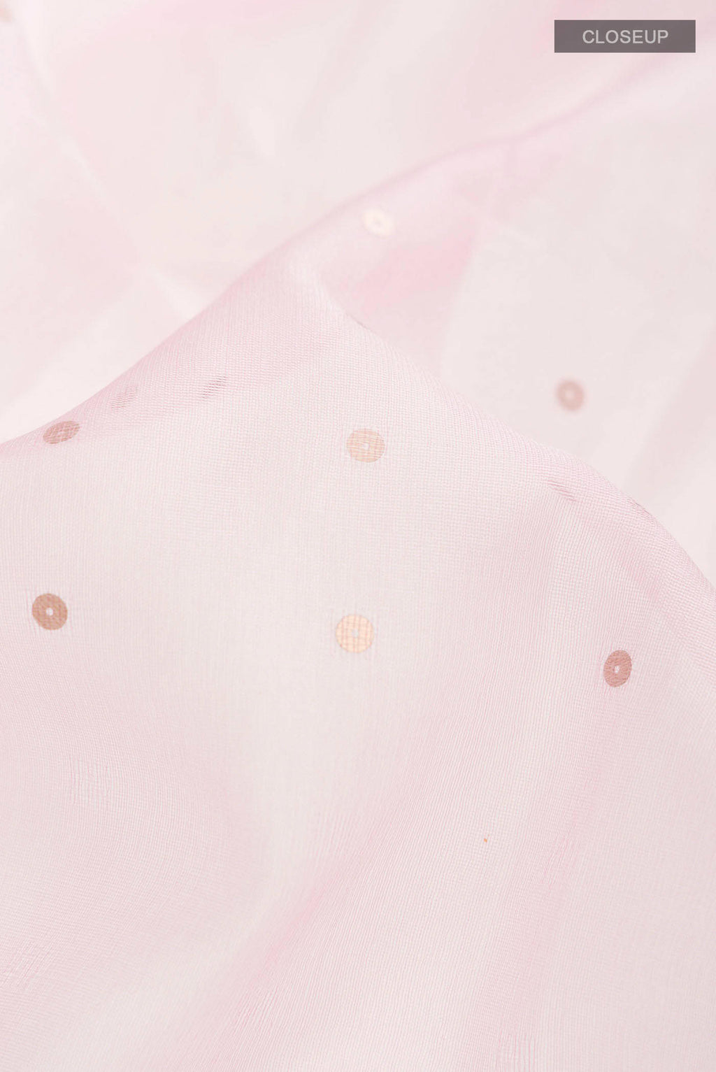 Close up of Pink Organza Silk Saree with Embroidery on the body and Embroidery Border displaying folds