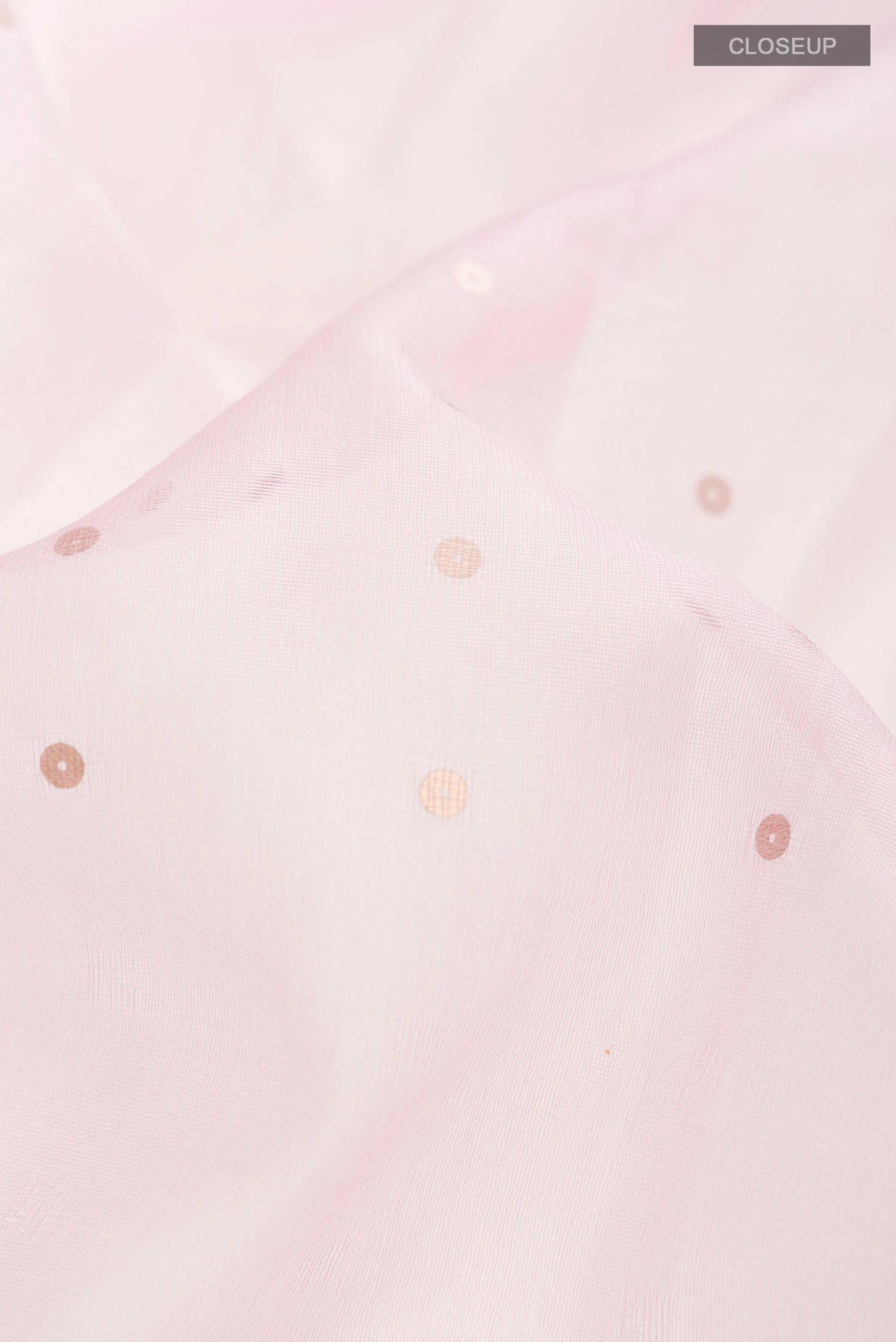 Close up of Pink Organza Silk Saree with Embroidery on the body and Embroidery Border displaying folds