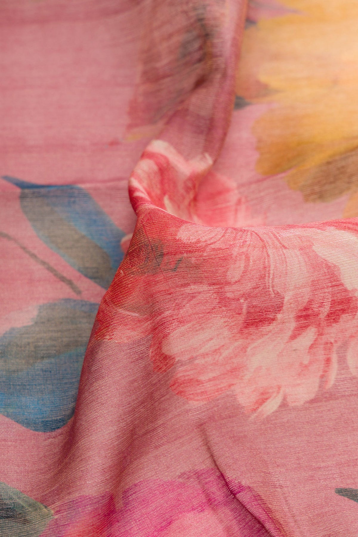 Close up of Rose pink Dual Tone Tussar Silk Saree with Printed design on the body and Embroidery Border.  displaying folds