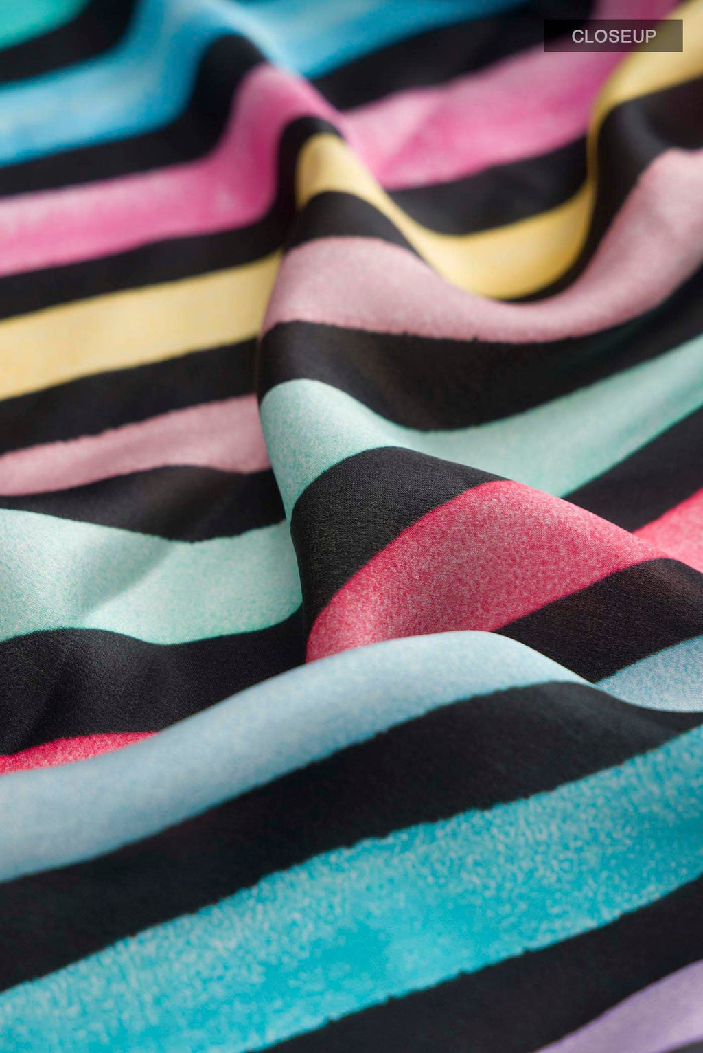 Close up of Multi Color Satin Crepe Saree with Printed design on the body and Plain Border displaying folds