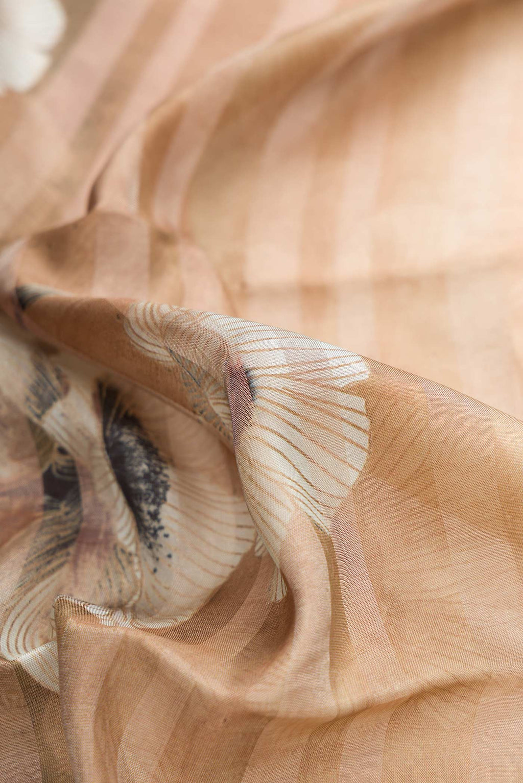 Close up of Beige Dual Tone Mysore Georgette Saree with Stripes on the body and Zari Border displaying folds
