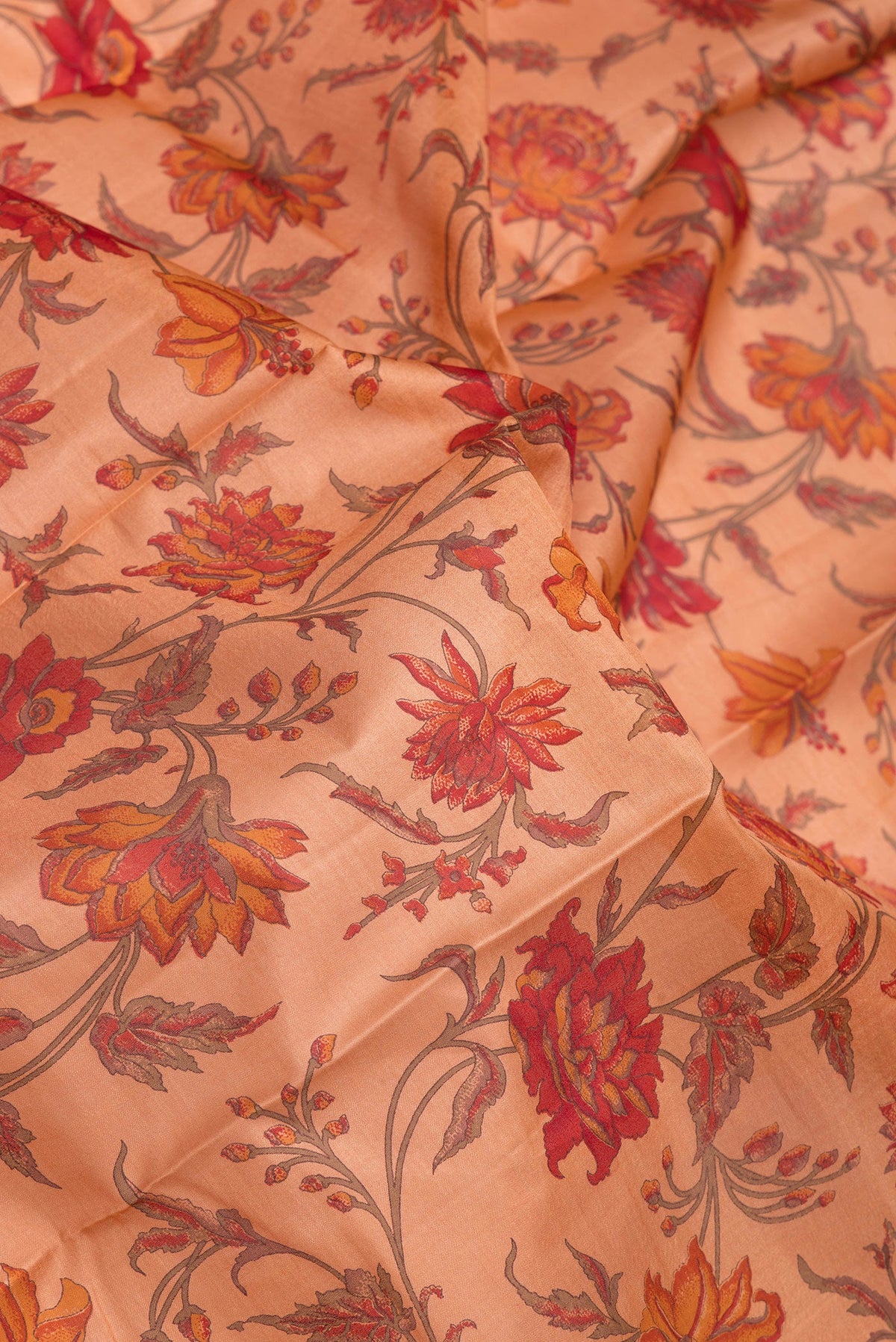 Close up of Peach Printed Silk Saree with Printed design on the body and Zari Border.  displaying folds