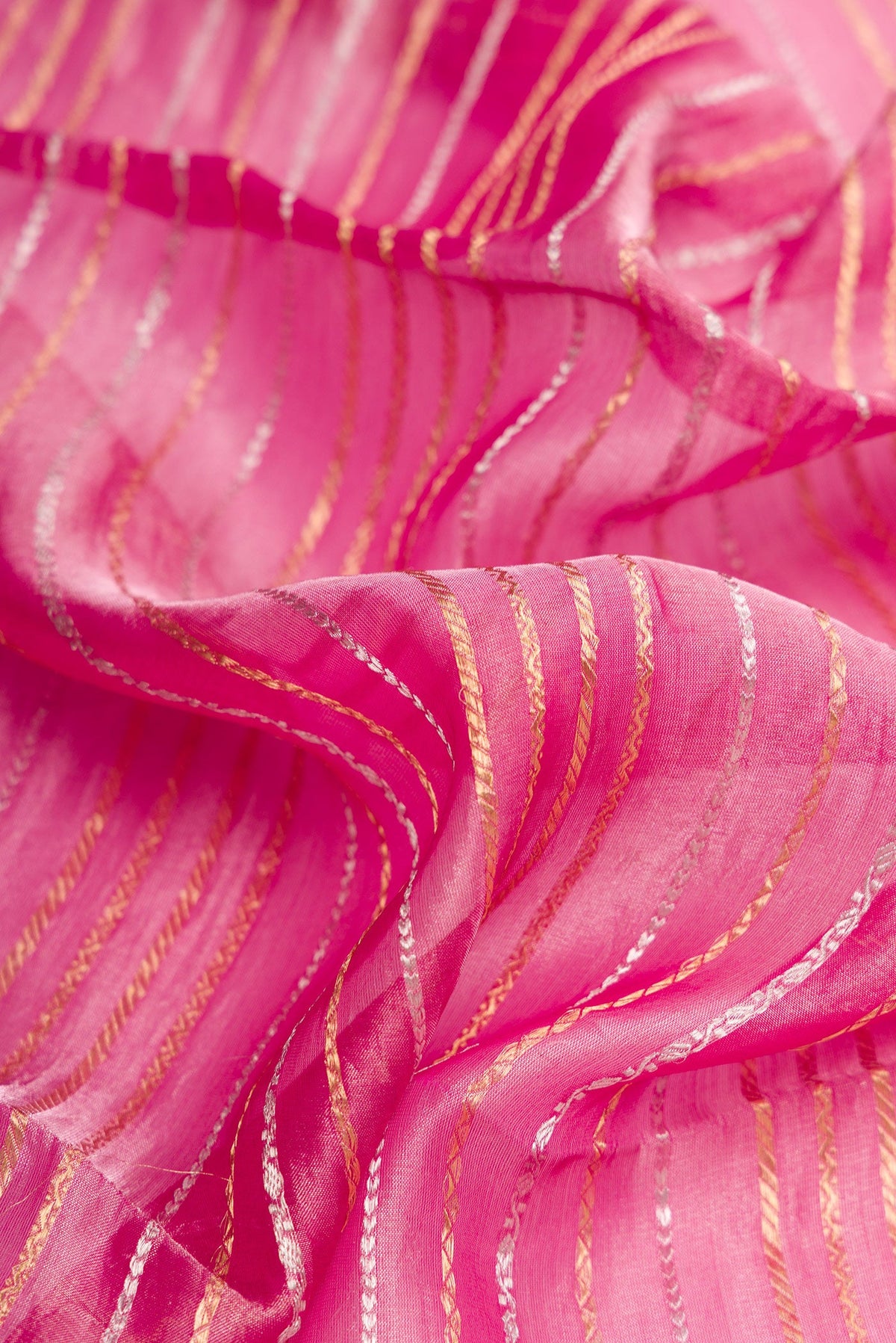 Close up of Pink Dual Tone Organza Silk Saree with Stripes on the body and Zari Border.  displaying folds