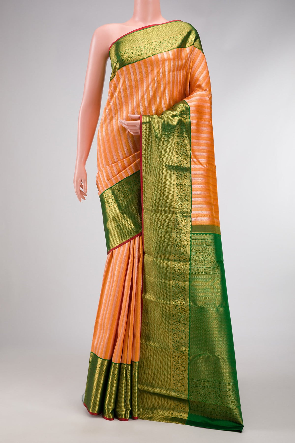 Peach Dual Tone Kanchipuram Silk Saree with Zari Brocade on the body and Zari Border.  displayed on a mannequin