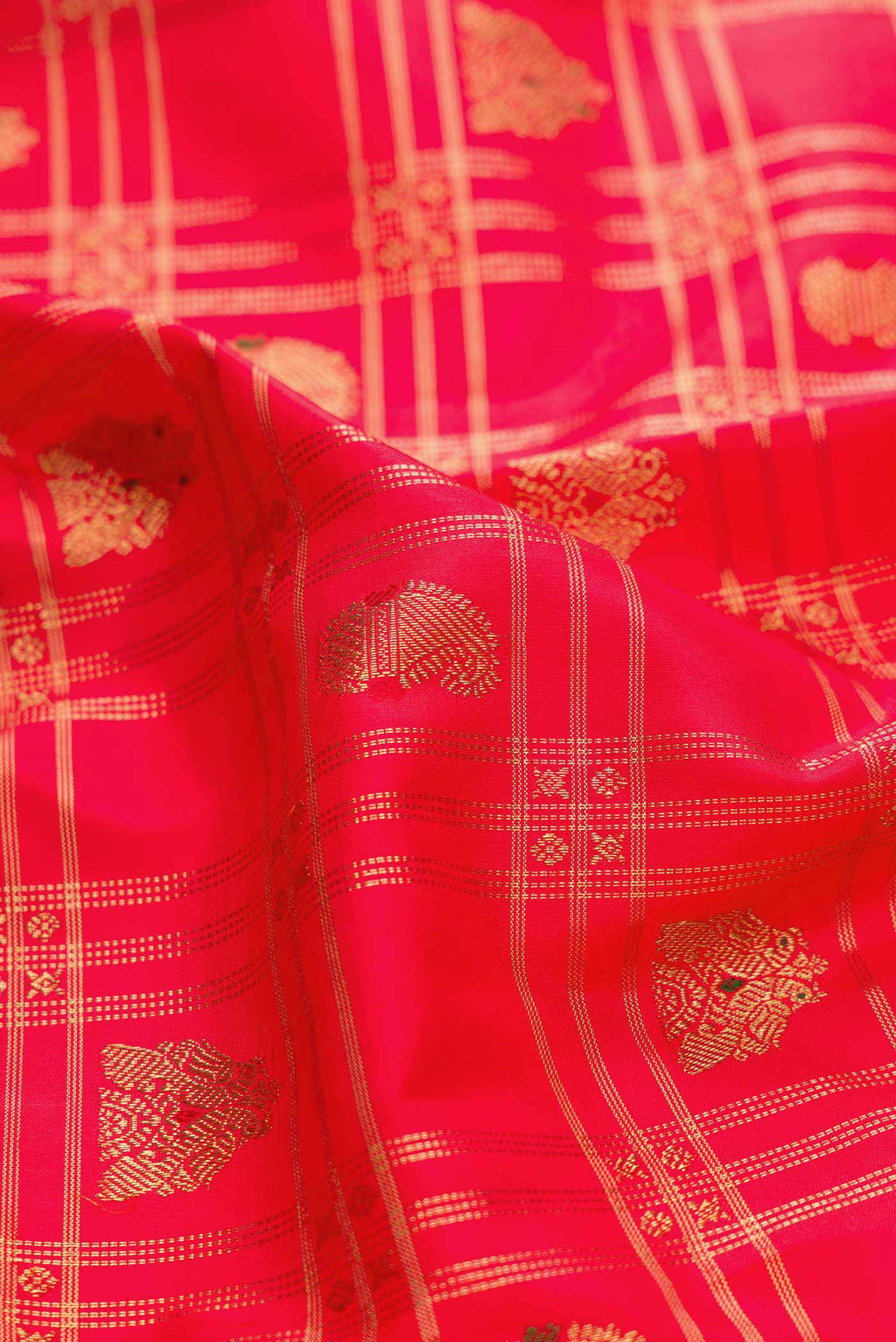 Close up of Red Dual Tone Kanchipuram Silk Saree with Checked design on the body and Zari Border displaying folds