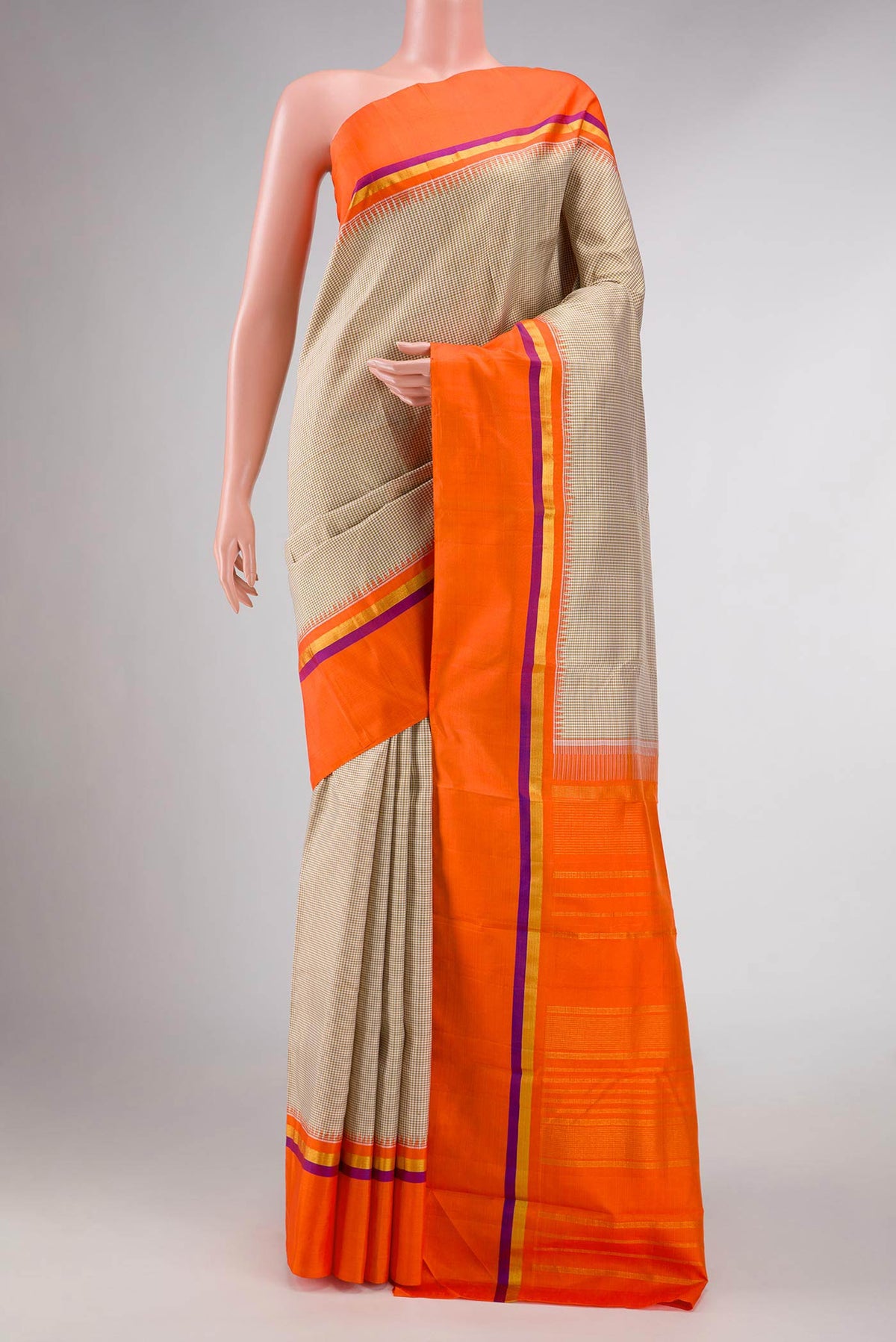 Beige Dual Tone Kanchipuram Silk Saree with Checked design on the body and Zari Border displayed on a mannequin