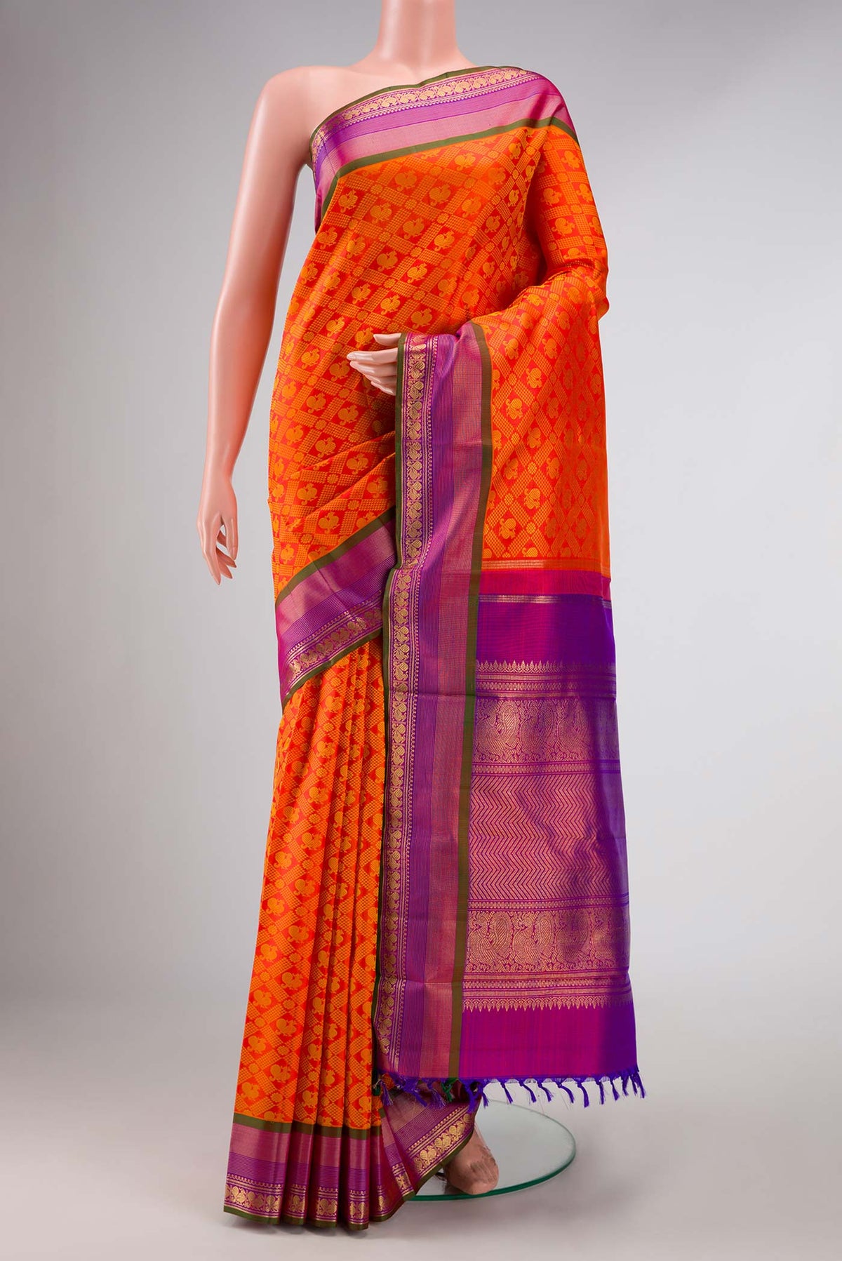 Pure Silk Pure Zari Orange Dual Tone Kanchipuram Saree with Jacquard design on the body and Zari Border displayed on a mannequin