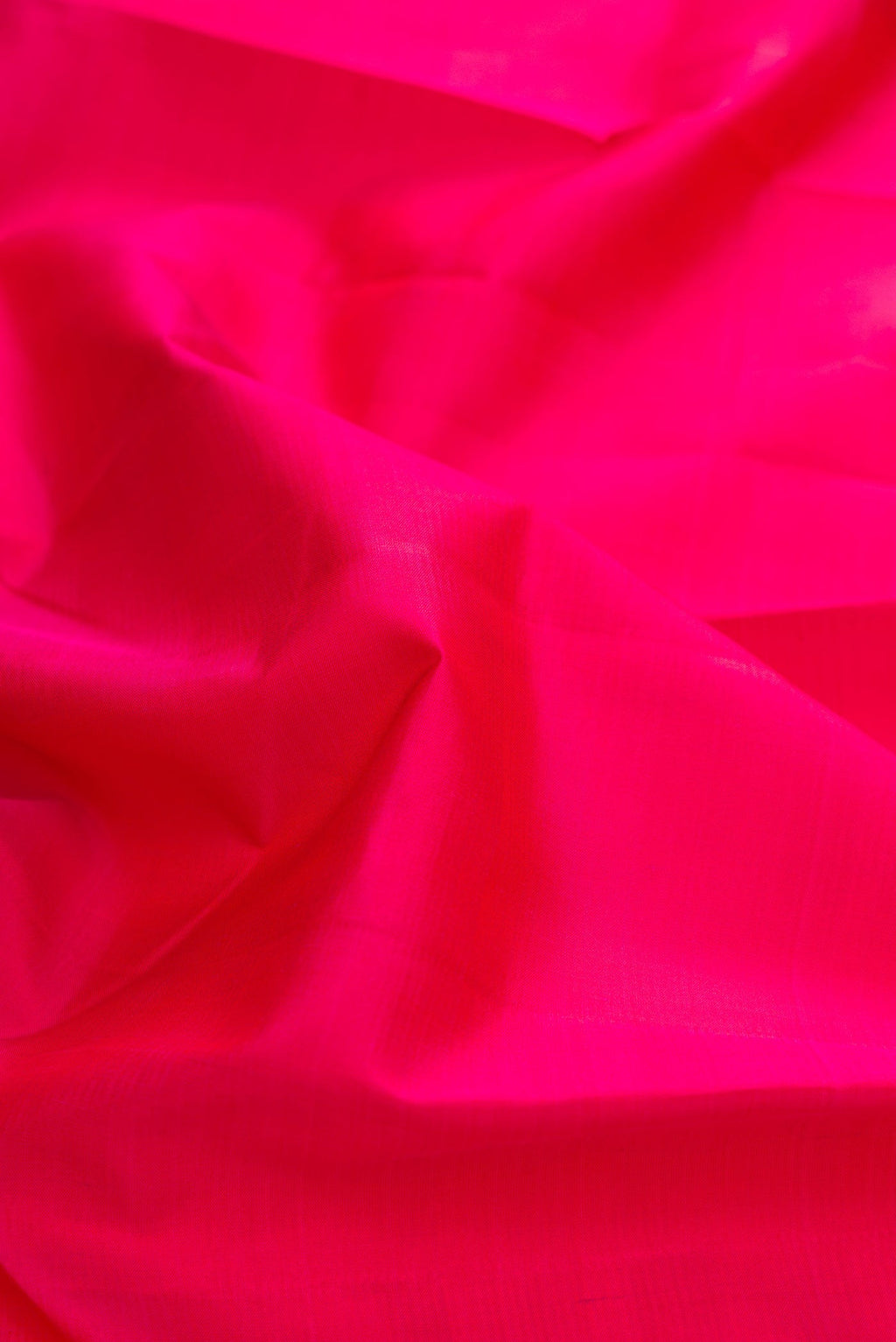 Close up of Pink Kanchipuram Silk Saree with Plain Body and Zari Border displaying folds