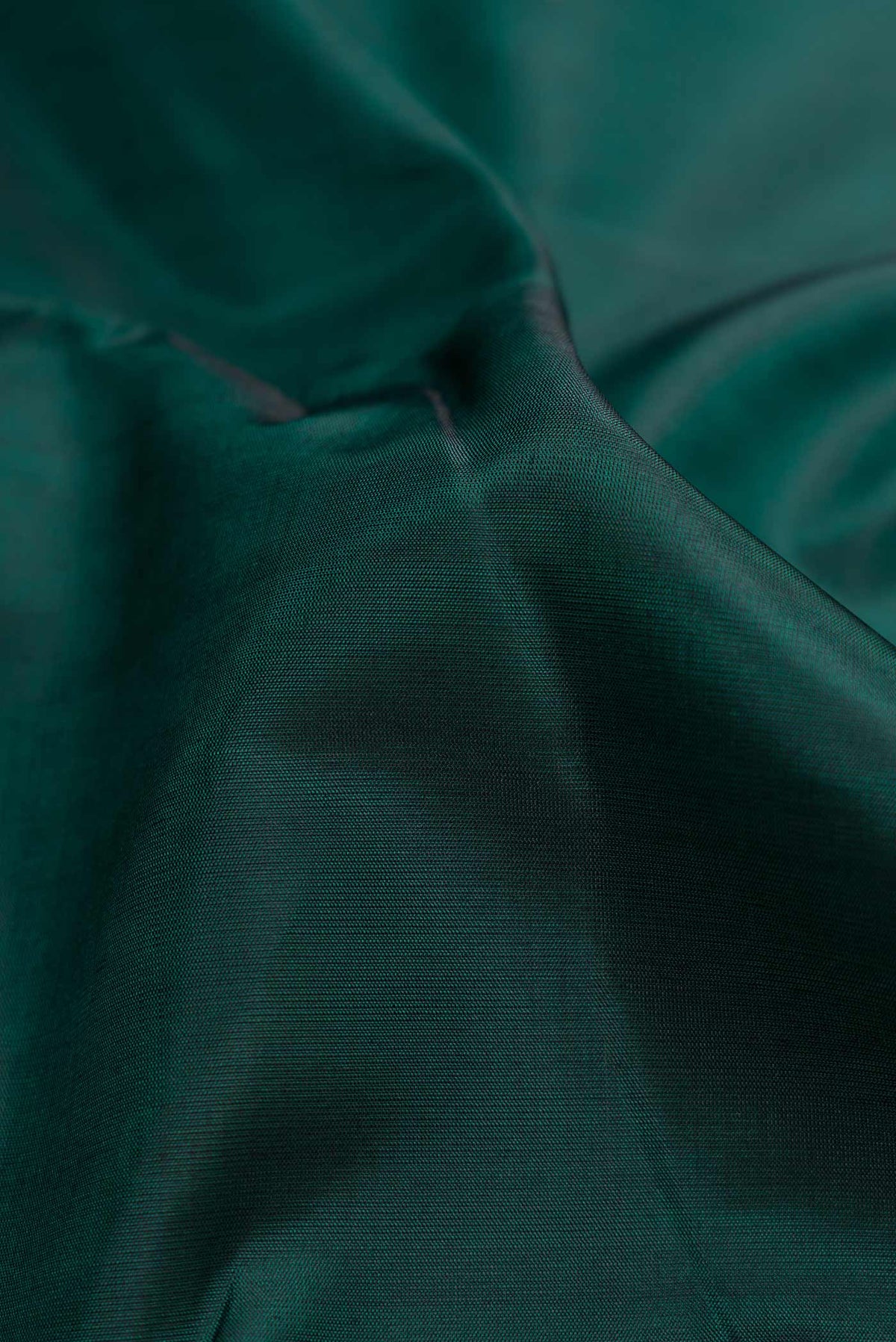 Close up of Bottle Green Dual Tone Kanchipuram Silk Saree with Plain Body and Checks Border.  displaying folds