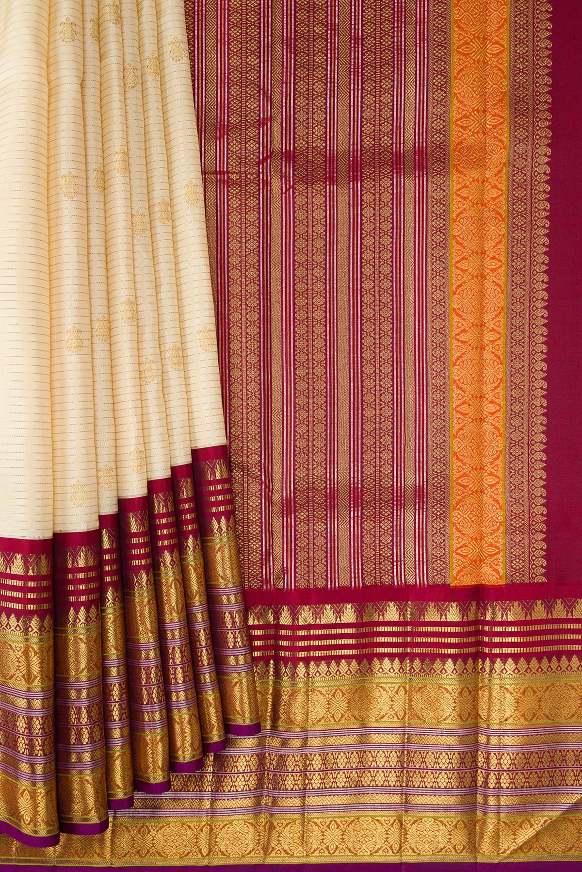 Pleats and pallu of Sandal Dual Tone Kanchipuram Silk Saree with Zari Butta on the body and Zari Border. 