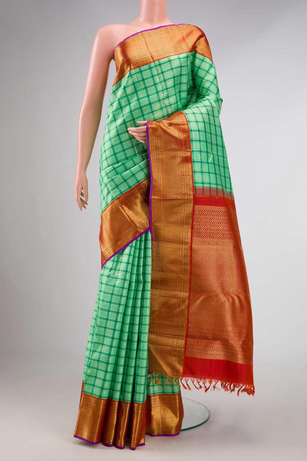 Pure Silk Pure Zari Sea Green Dual Tone Kanchipuram Saree with Checked design on the body and Zari Border displayed on a mannequin