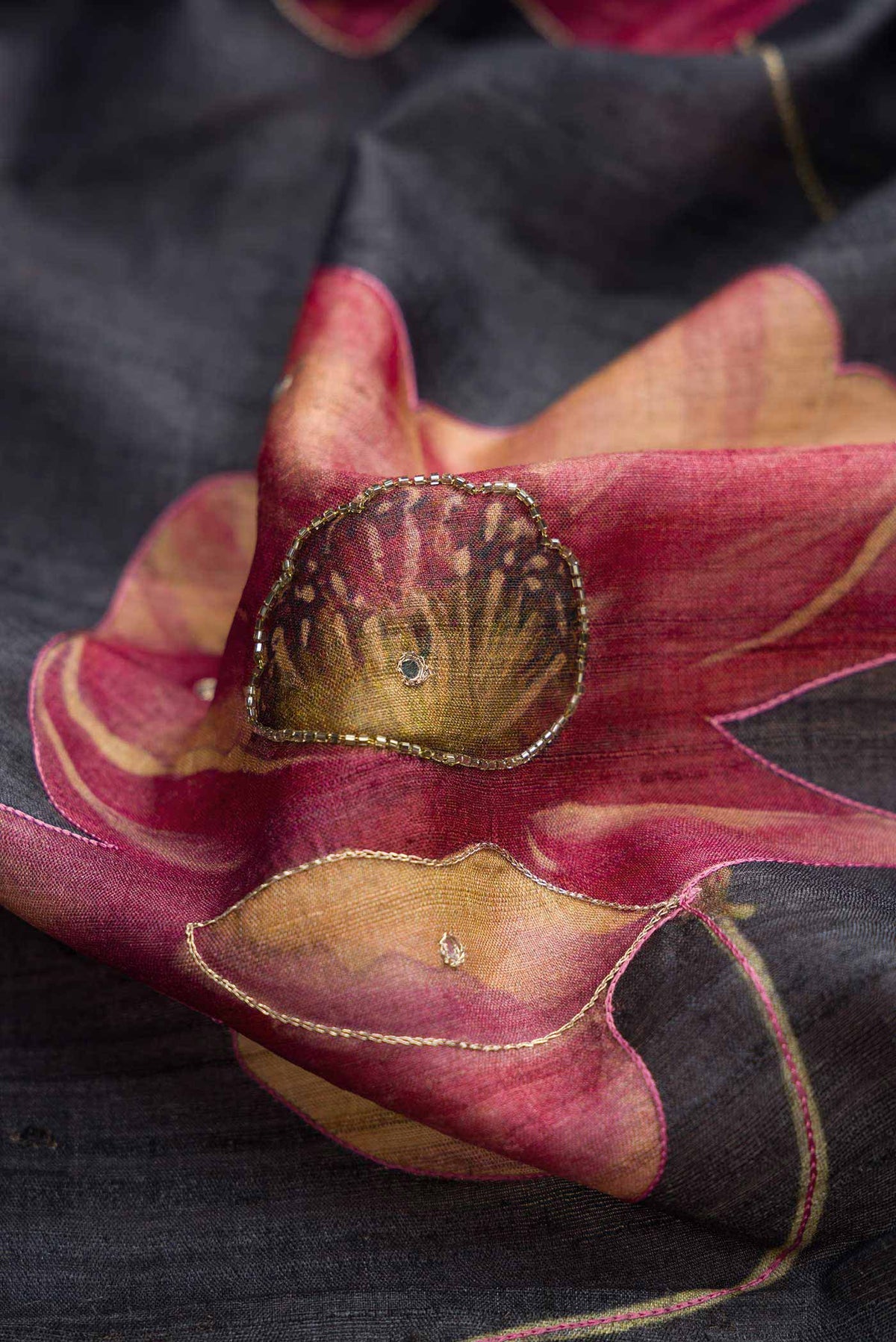 Close up of Black Dual Tone Tussar Silk Saree with Embroidery on the body and Embroidery Border displaying folds