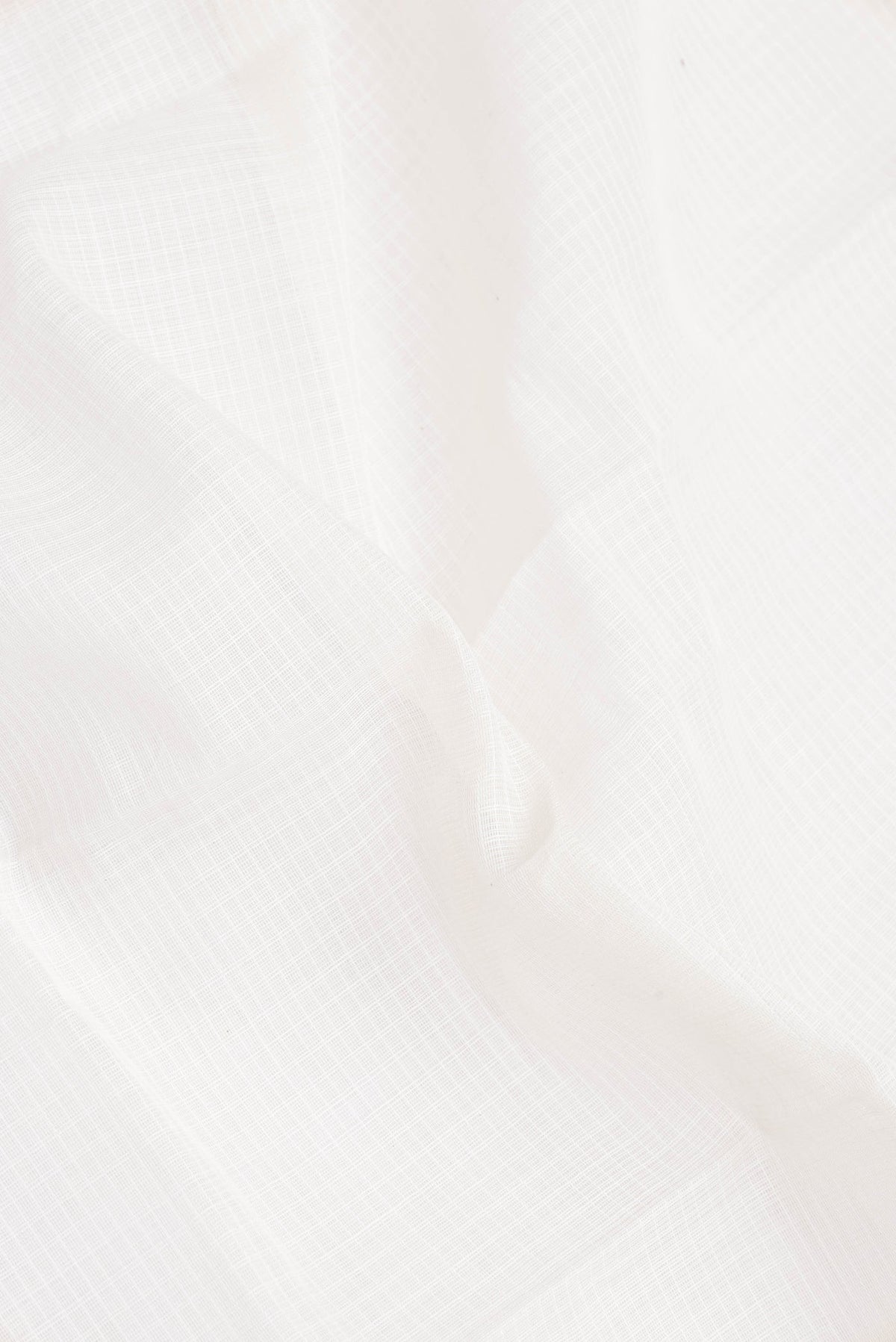 Close up of White Gadwal cotton Saree with Checked design on the body and Zari Border.  displaying folds