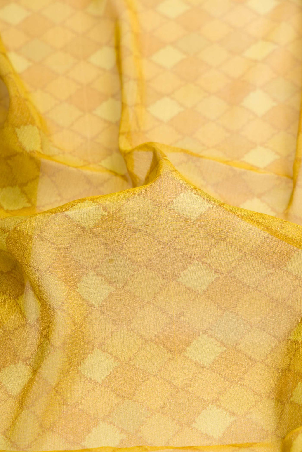 Close up of Mehandi Green Dual Tone Mysore Georgette Saree with Printed design on the body and Fancy Border displaying folds