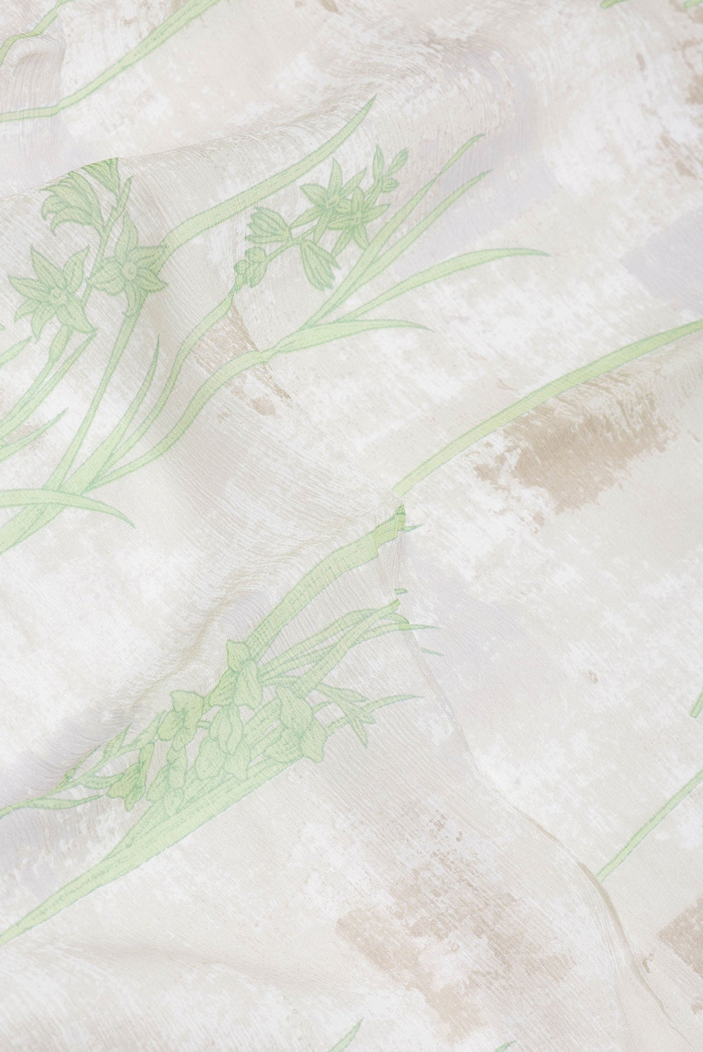 Close up of Beige Dual Tone Mysore Georgette Saree with Printed design on the body and Zari Border.  displaying folds