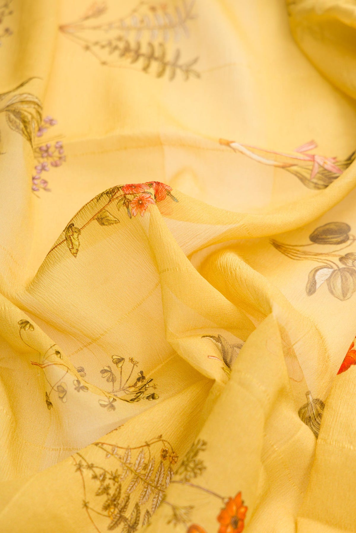 Close up of Mustard Dual Tone Mysore Georgette Saree with Printed design on the body and Zari Border displaying folds