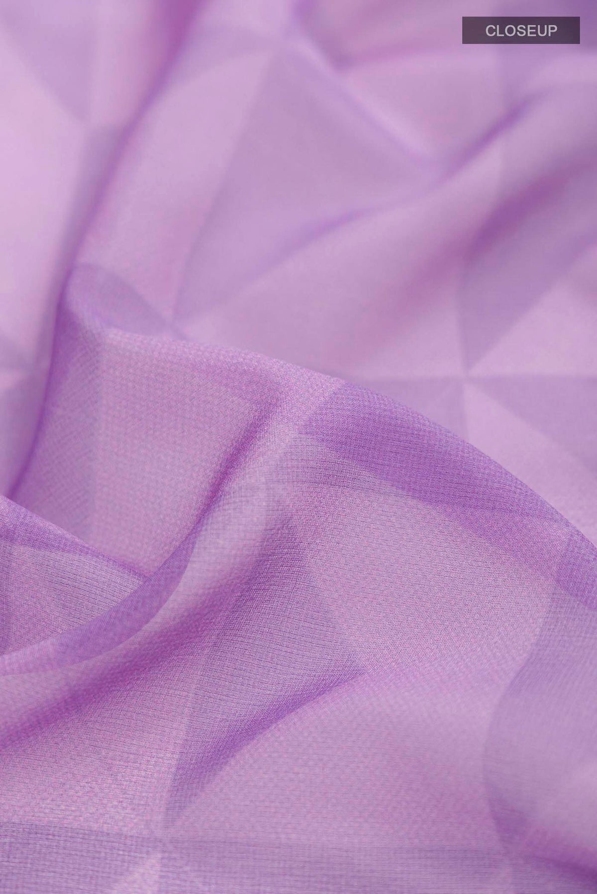 Close up of Lavender Georgette Saree Printed design on the body and Zari Border displaying folds