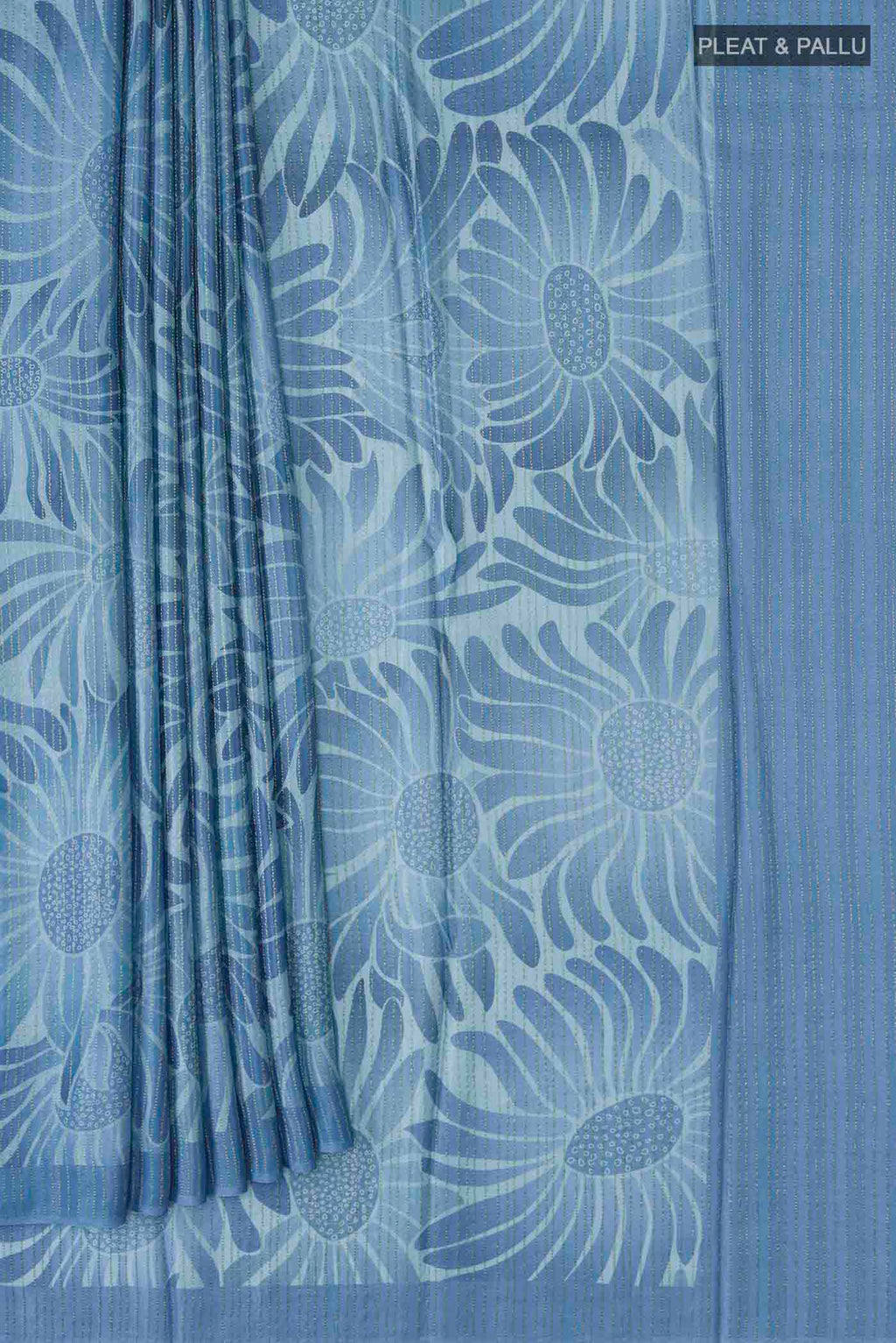 Pleats and pallu of Blue Crepe Saree Printed design on the body and Zari Border