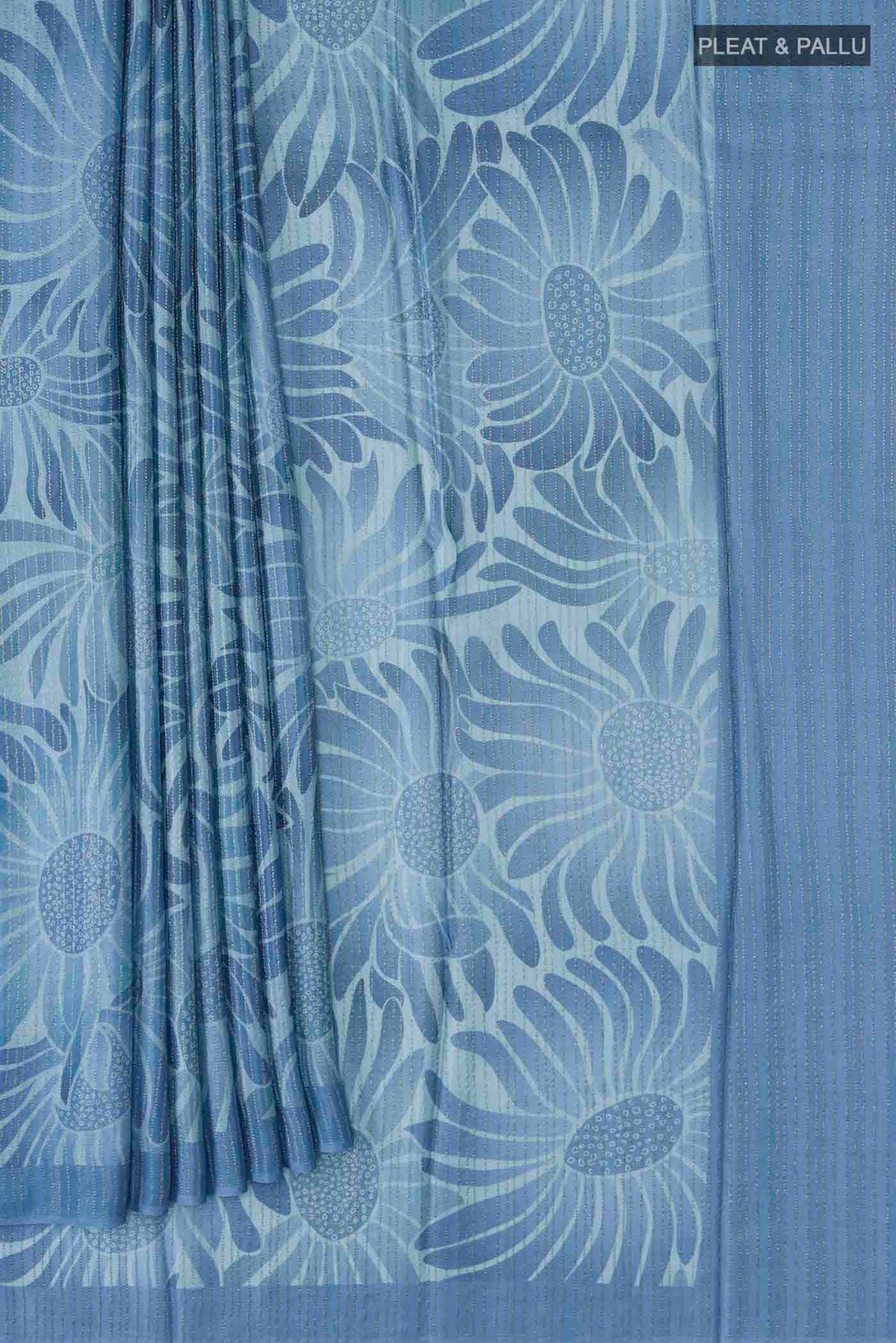 Pleats and pallu of Blue Crepe Saree Printed design on the body and Zari Border