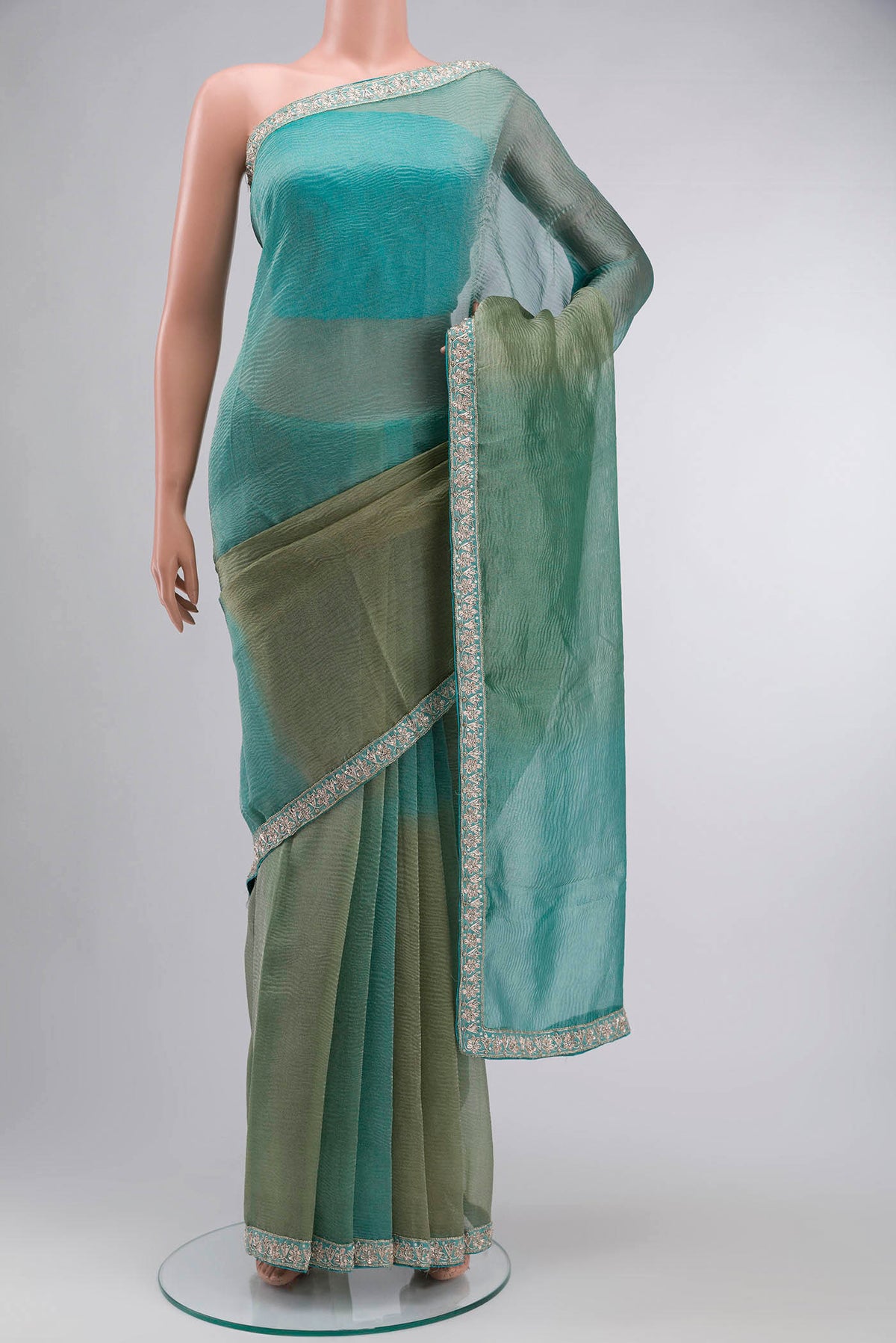 Multi Tissue Silk Saree with Plain Body and Embroidery Border displayed on a mannequin