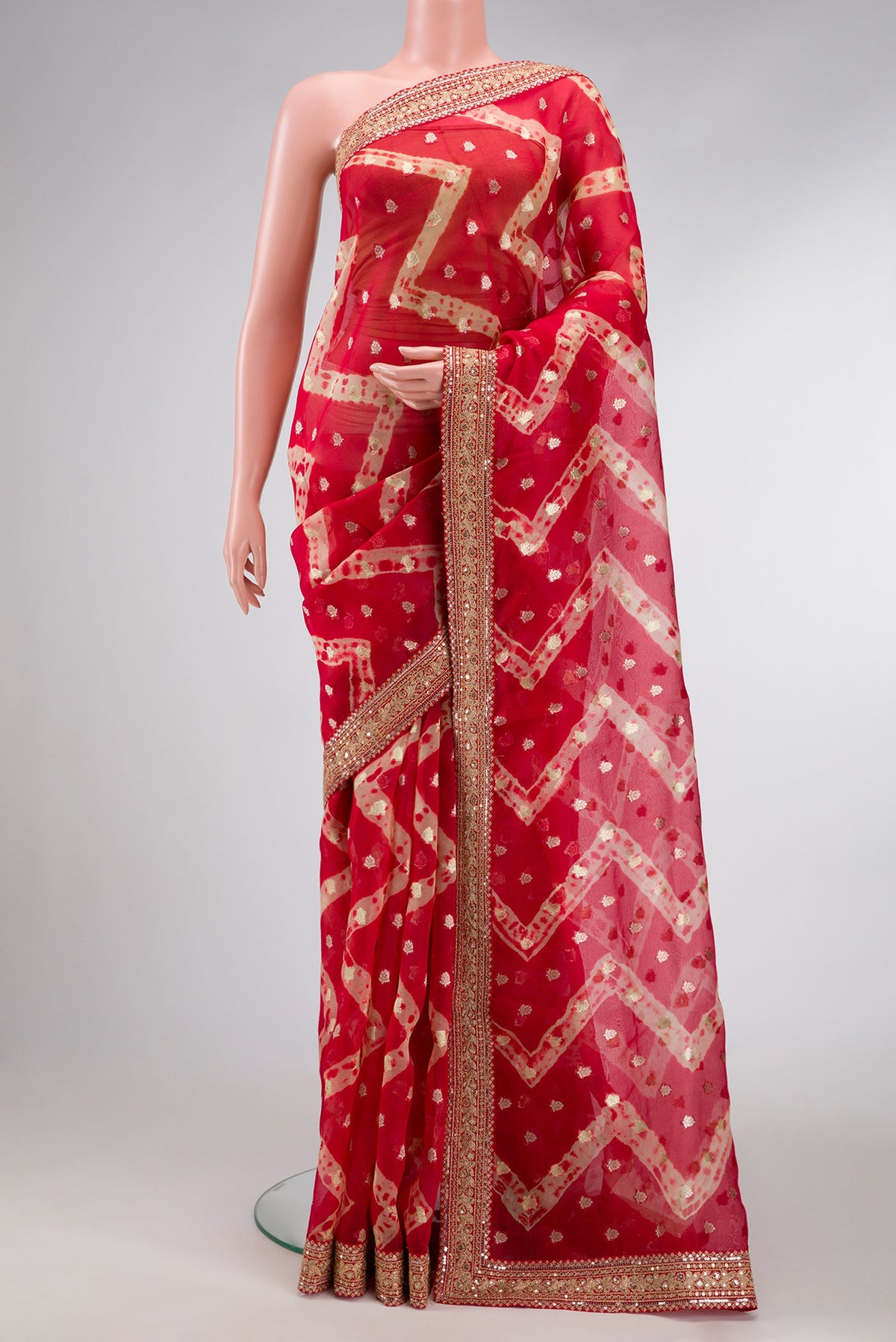 Red Dual Tone Organza Silk Saree with Zari Butta on the body and Embroidery Border.  displayed on a mannequin