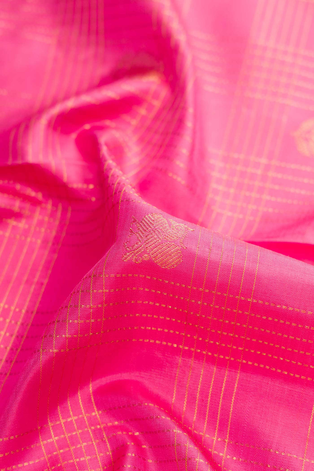 Close up of Pink Dual Tone Kanjivaram Silk Saree with Checked design on the body and Zari Border.  displaying folds