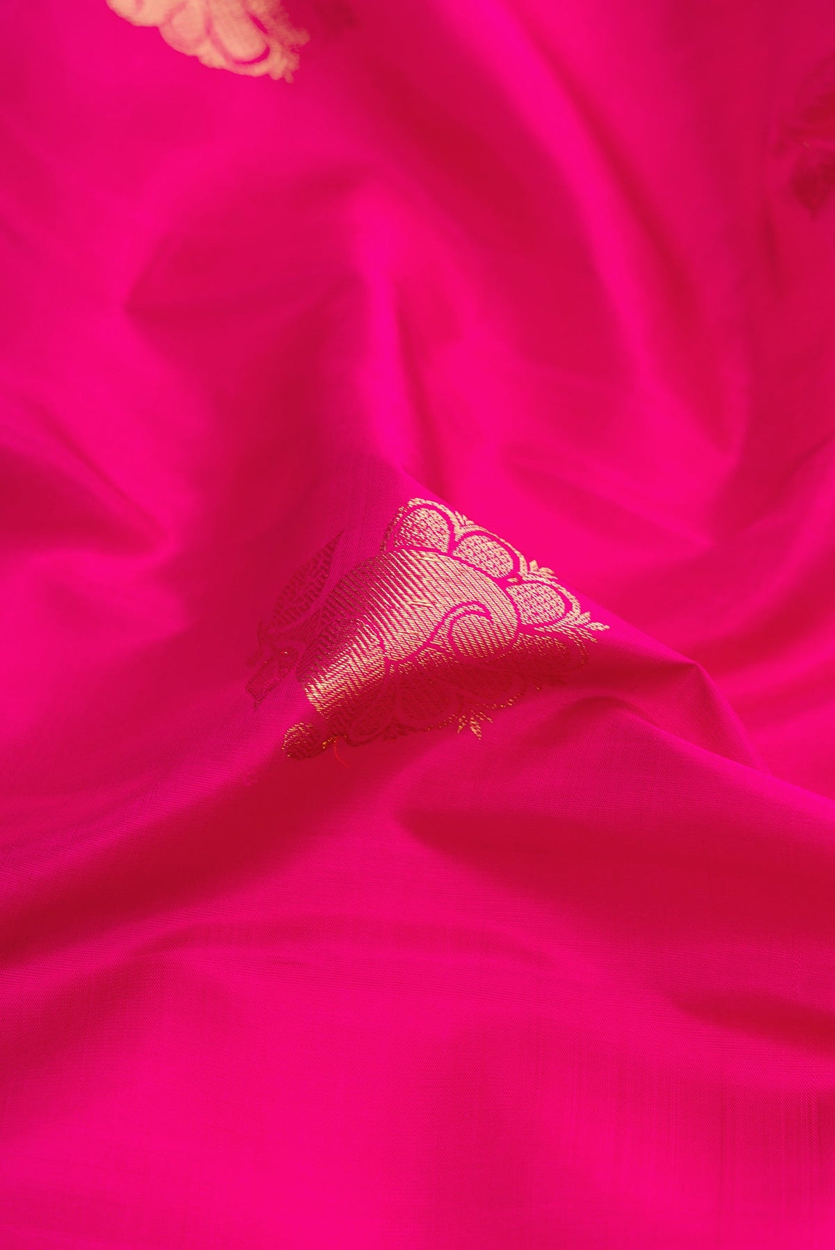 Close up of Pink Dual Tone Kanchipuram Silk Saree with Zari Butta on the body and Zari Border.  displaying folds
