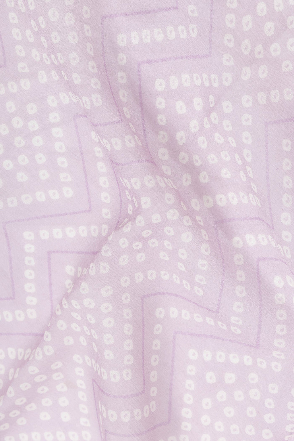 Close up of Lavender Dual Tone Mysore Georgette Saree with Bandhani Print on the body and Zari Border.  displaying folds