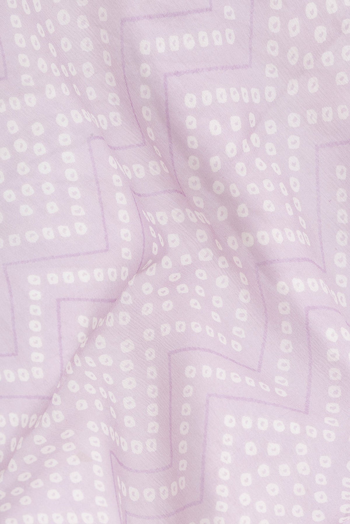Close up of Lavender Dual Tone Mysore Georgette Saree with Bandhani Print on the body and Zari Border.  displaying folds