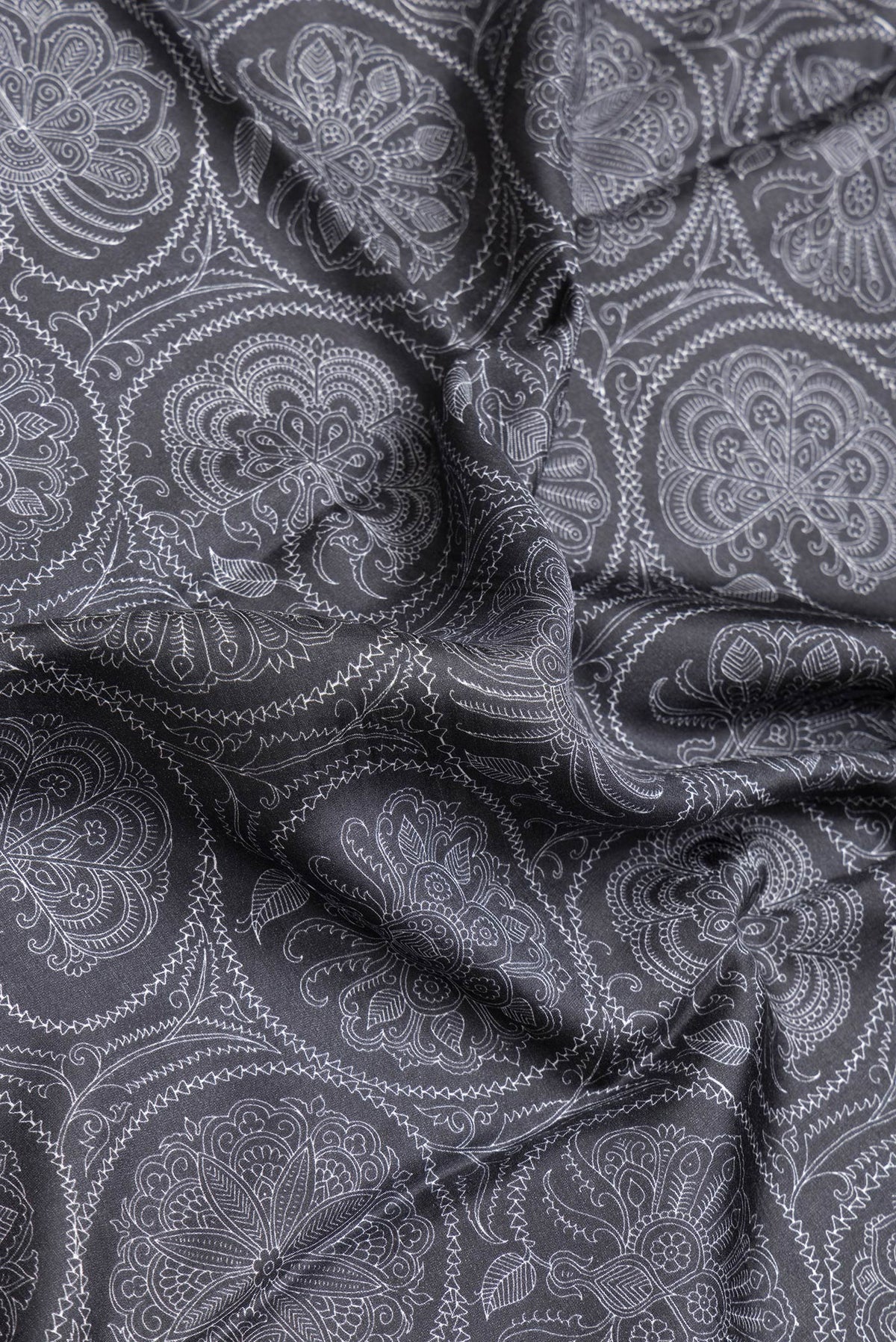 Close up of Black Dual Tone Printed Silk Saree with Printed design on the body and Plain Border.  displaying folds