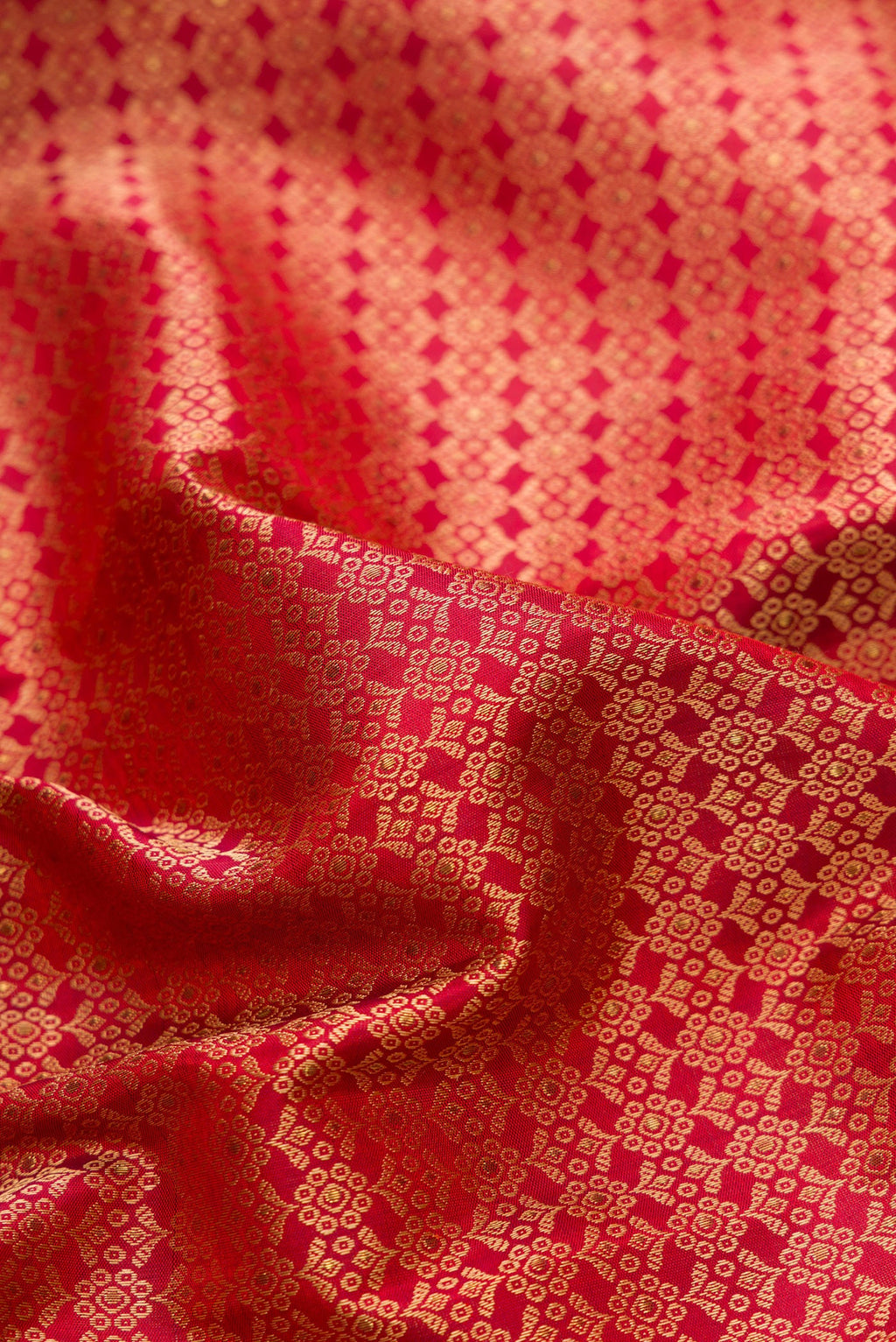 Close up of Pure Silk Pure Zari Maroon Dual Tone Kanchipuram Saree with Jacquard design on the body and Fancy Border.  displaying folds